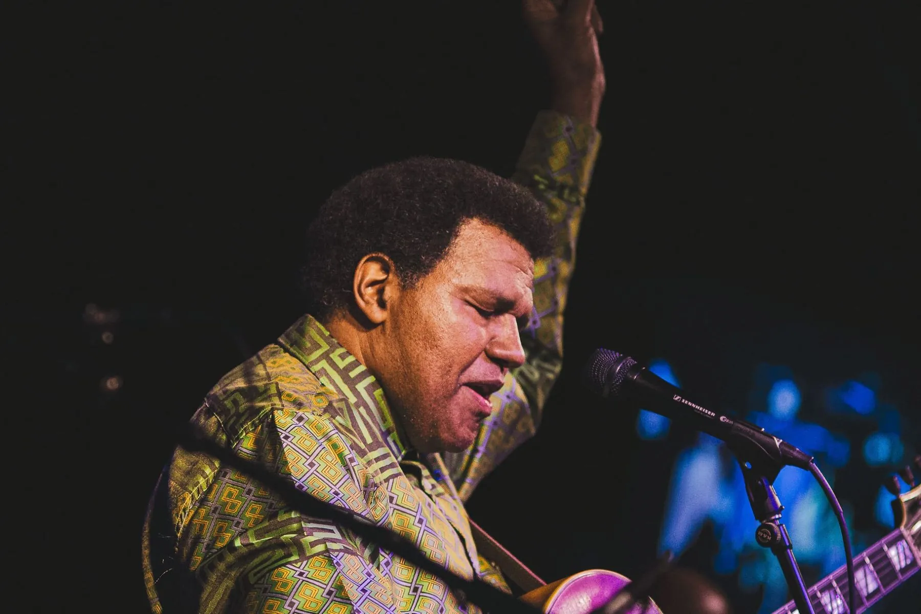 Pascal Bokar performing guitar onstage with the AfroBlueGrazz Band
