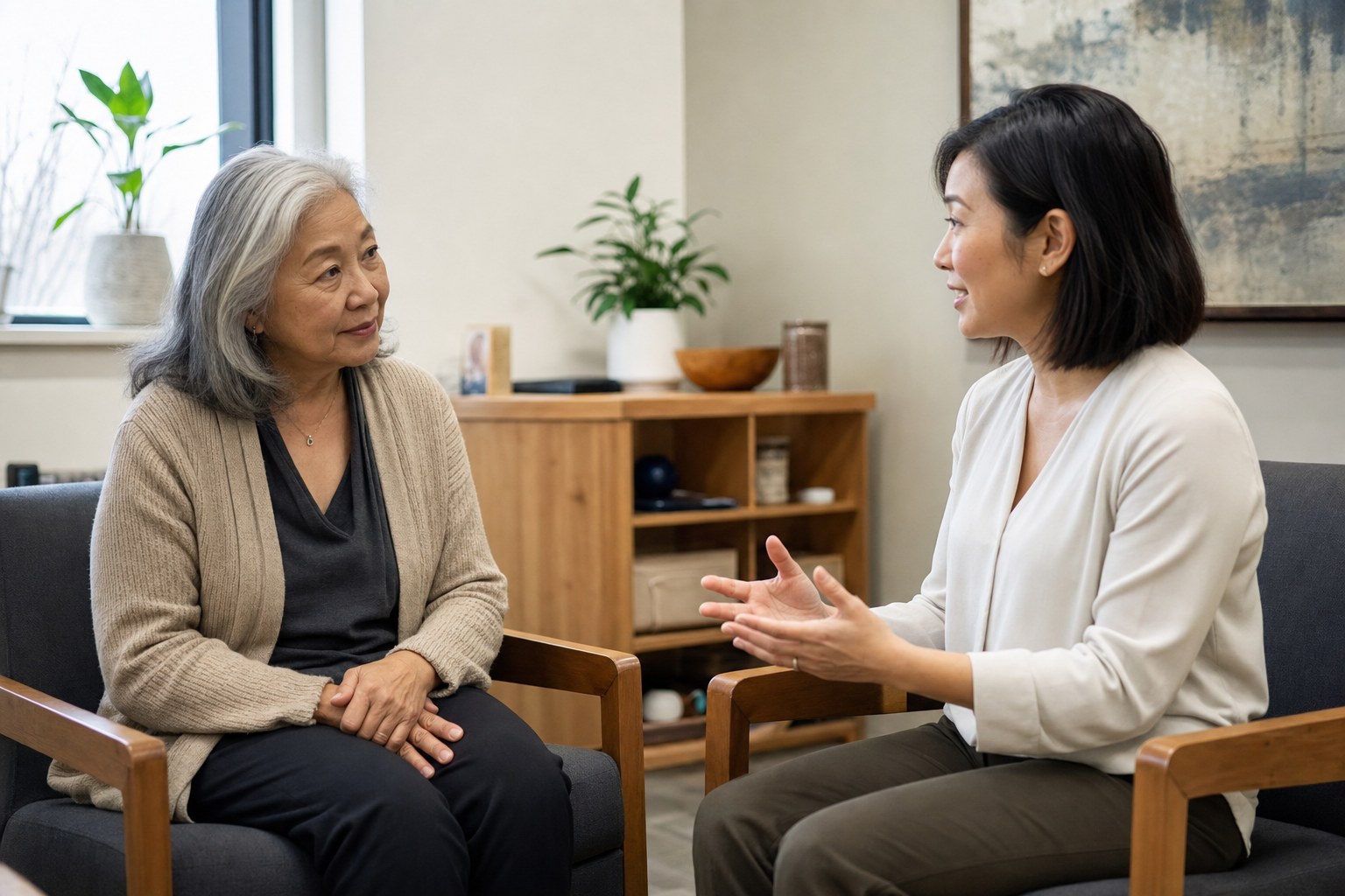 An older woman speaking with a clinician in a quiet office