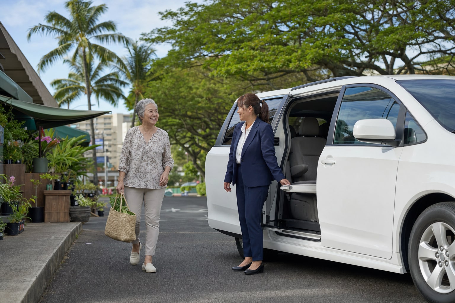 A female driver helping an older woman beside a white passenger minivan
