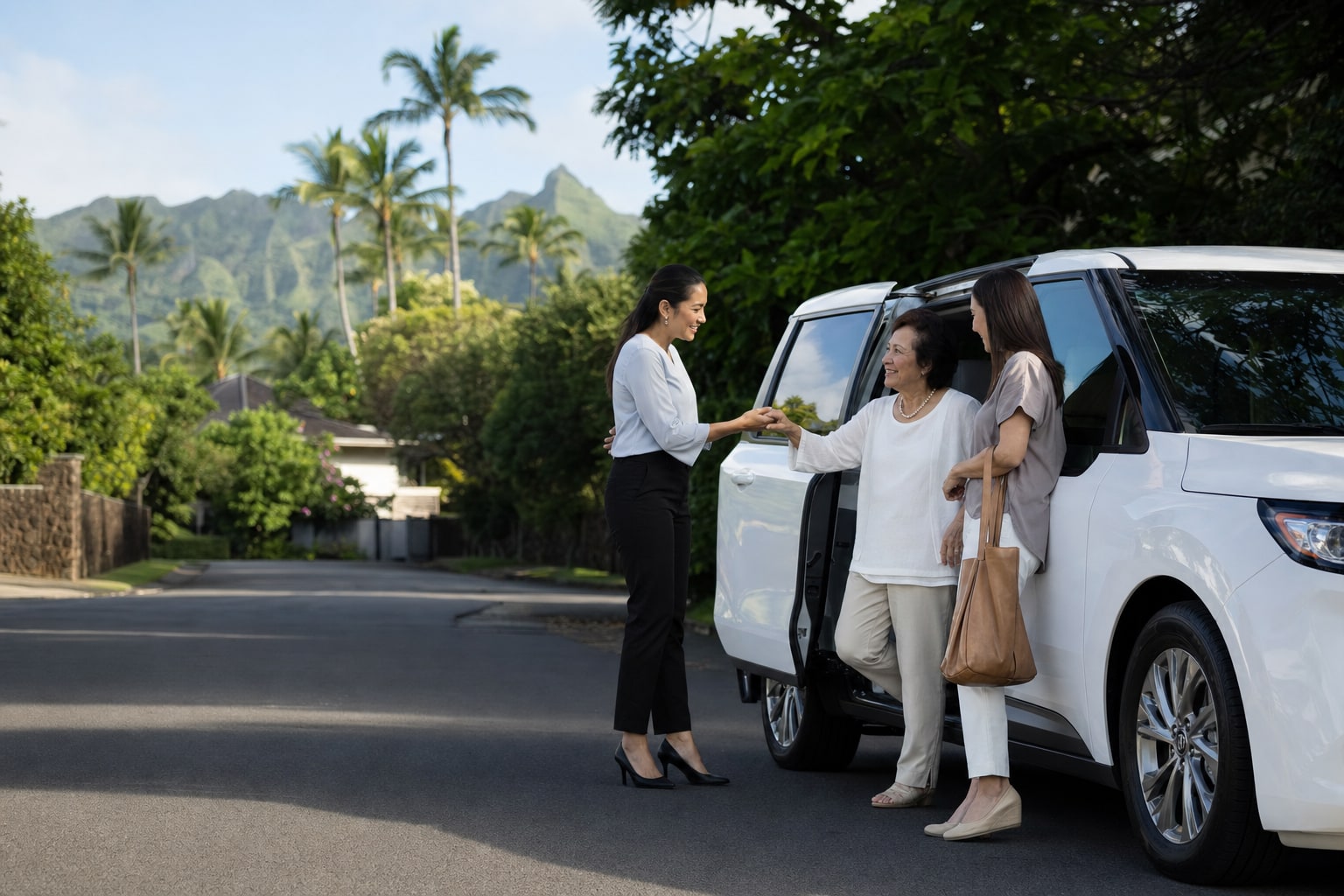 A female driver greeting an older member-client beside a white passenger minivan