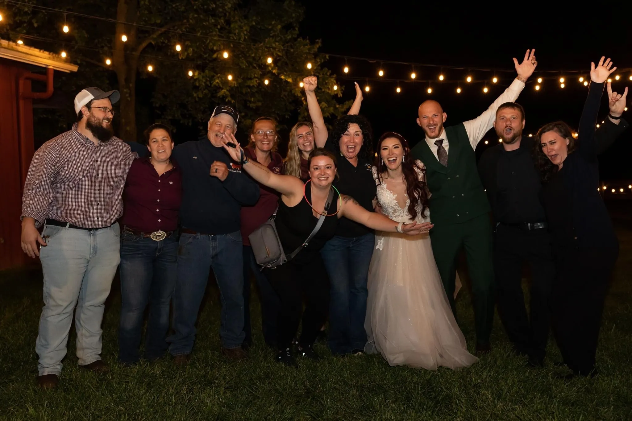Warmly lit wedding reception inside the Oak Creek Farm barn
