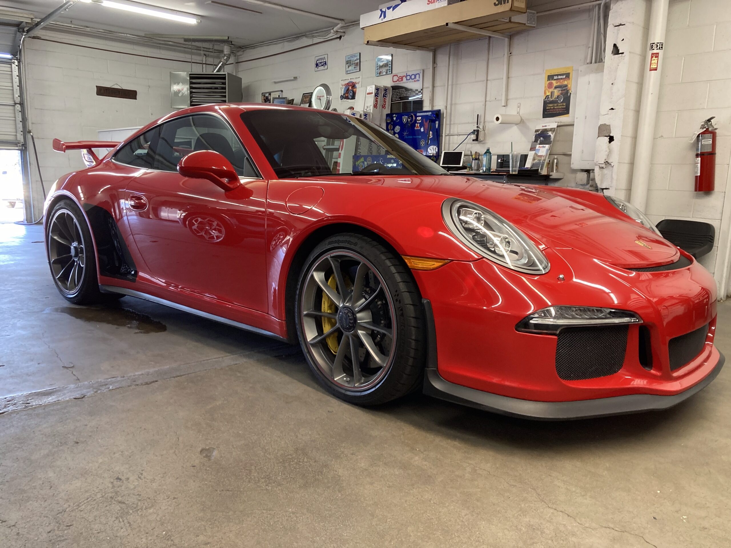 Red performance car in the Premier Glass Tinting workshop