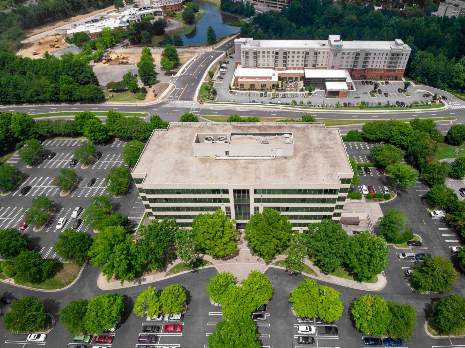 Aerial property photograph in Duluth showing a building, trees, and surrounding parking