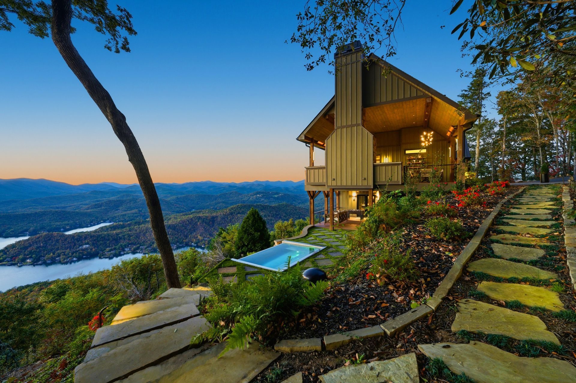 Vacation rental overlooking a lake and mountains at twilight