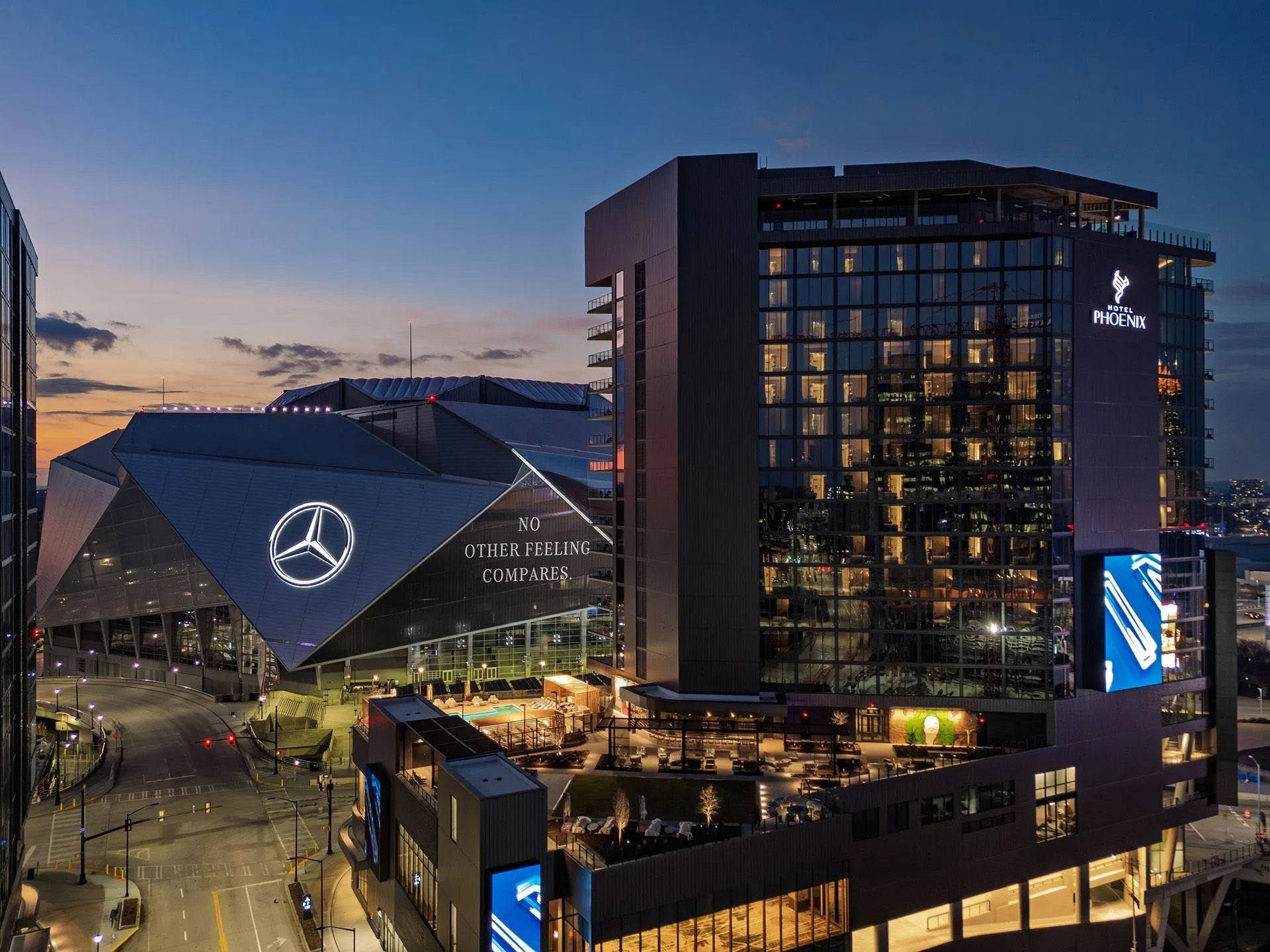 Hotel Phoenix and Mercedes-Benz Stadium at twilight in Centennial Yards, Atlanta