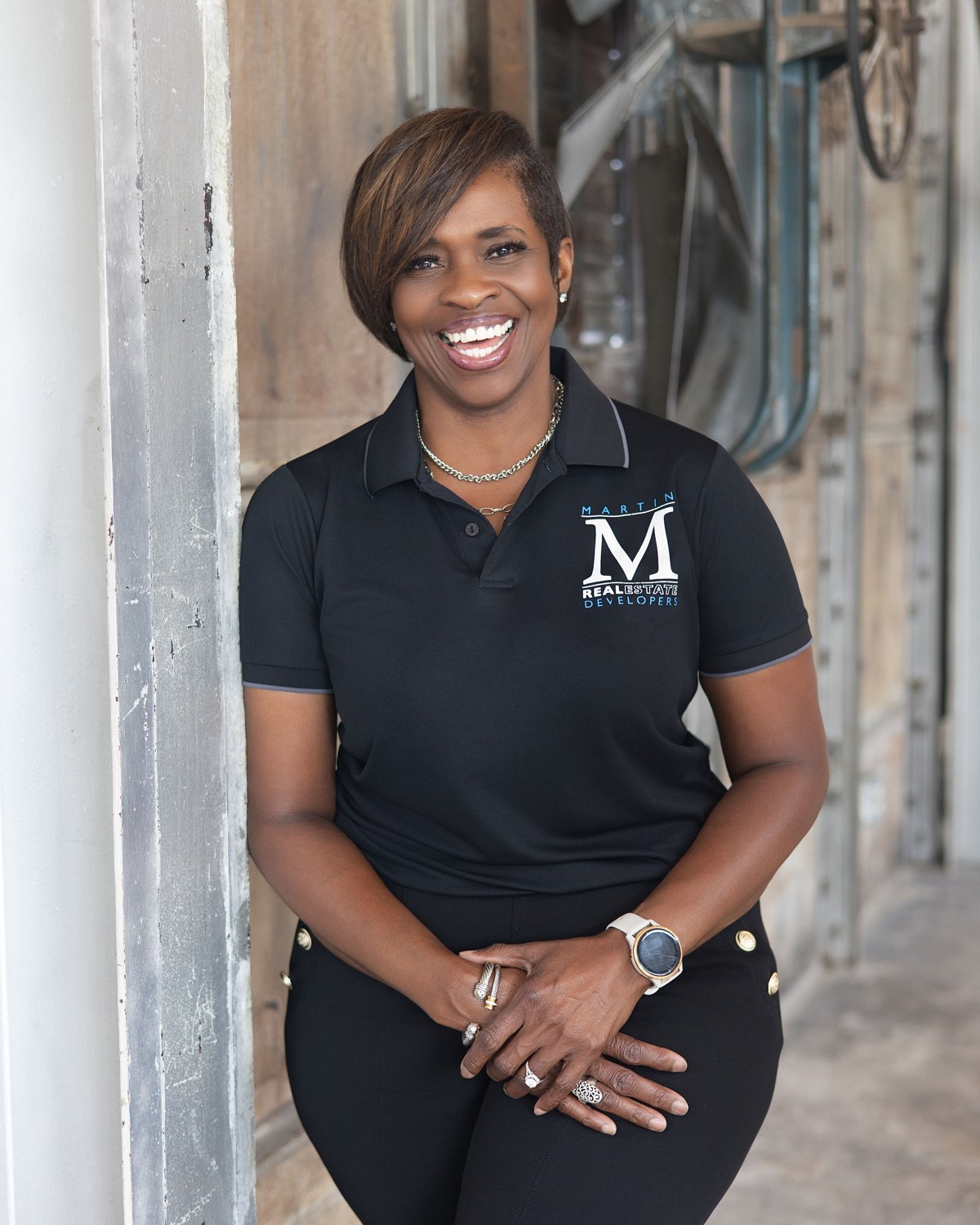 On-location portrait of a smiling woman in a black polo