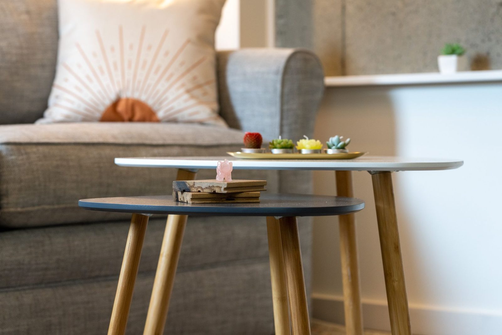 A living room with a couch and two tables