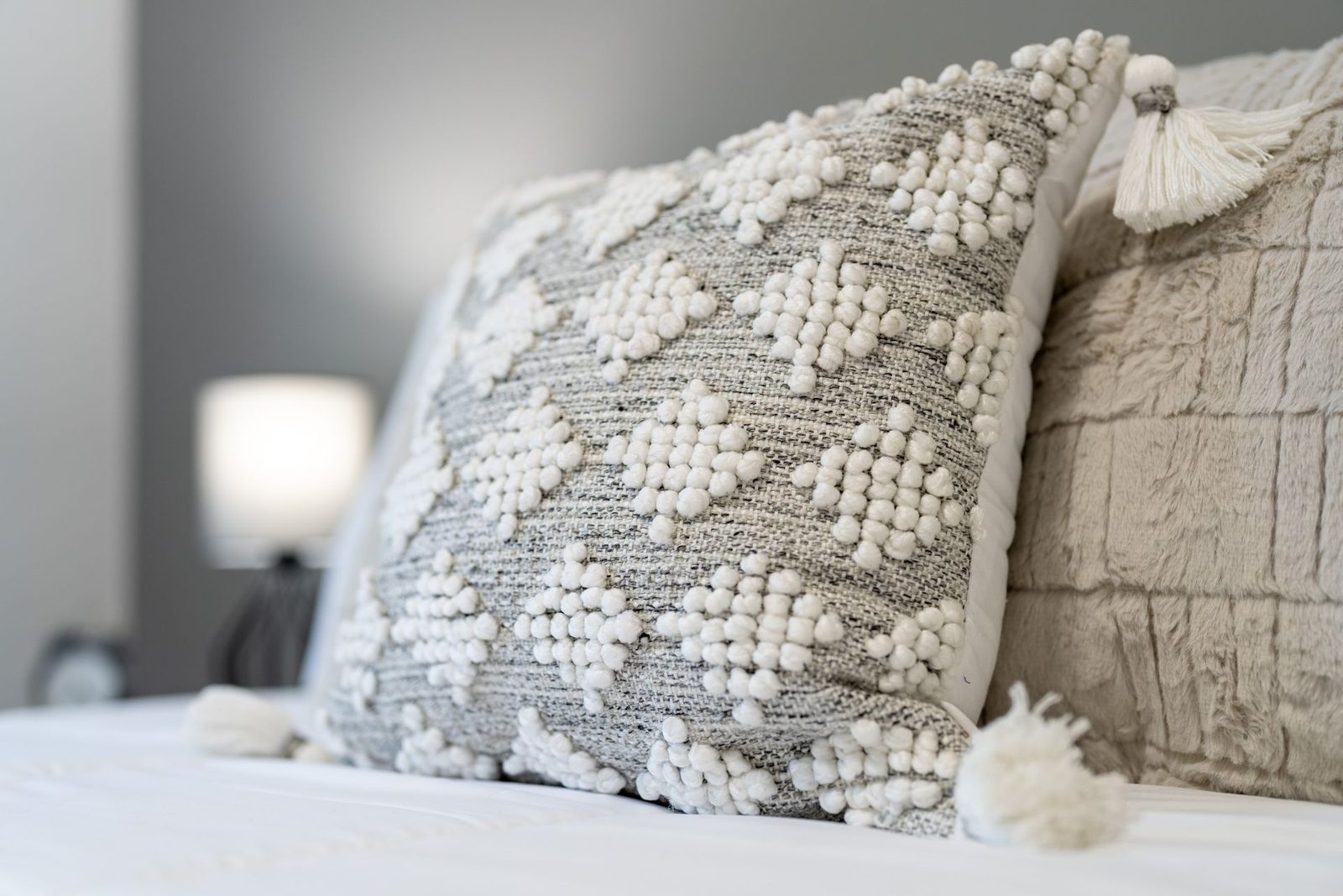 A close up of two pillows on a bed.