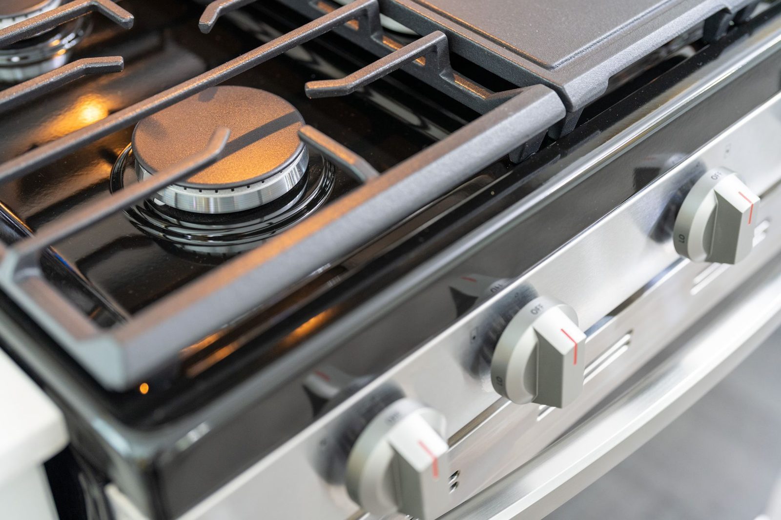 A close up of a gas stove with four burners.