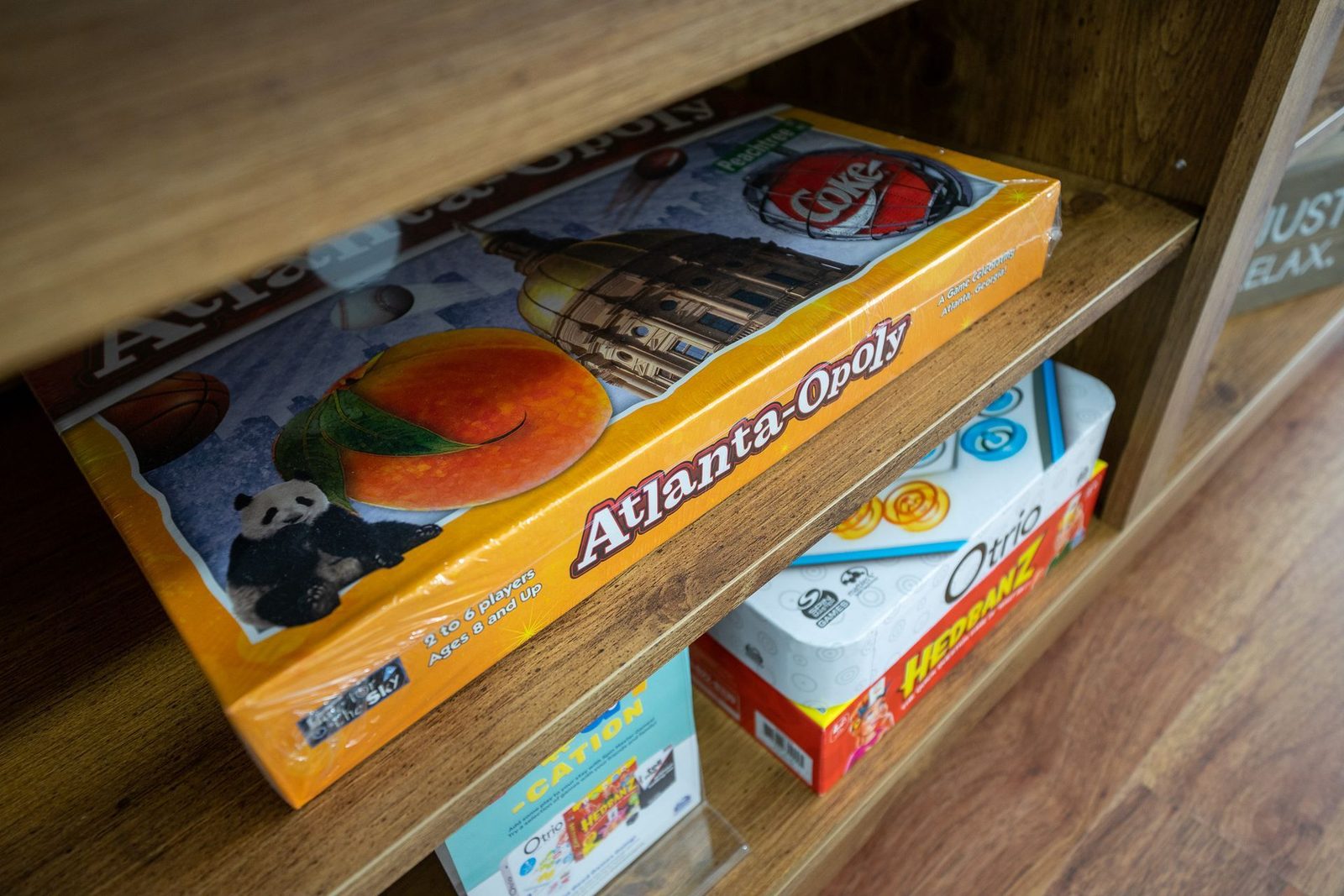 A box of atlanta oysters is sitting on top of a wooden shelf.