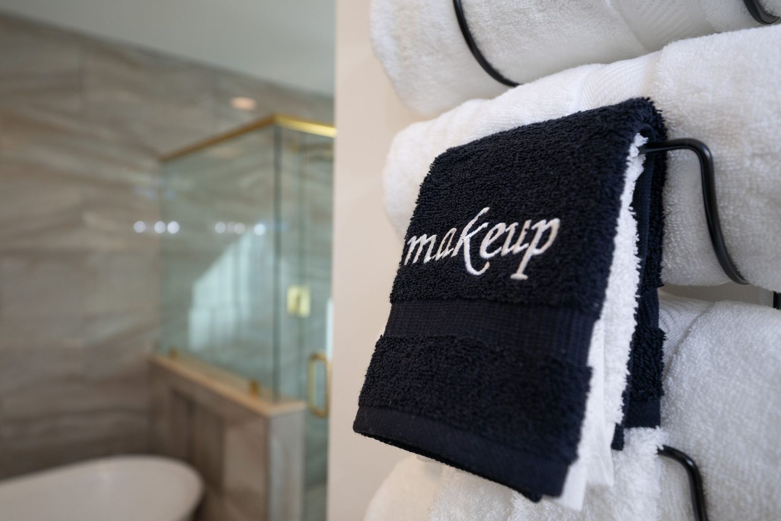 A black and white towel with the word makeup embroidered on it