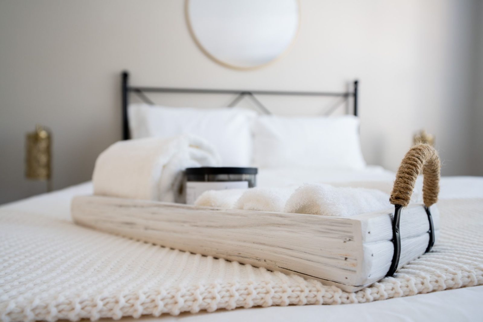 A white tray is sitting on top of a bed.