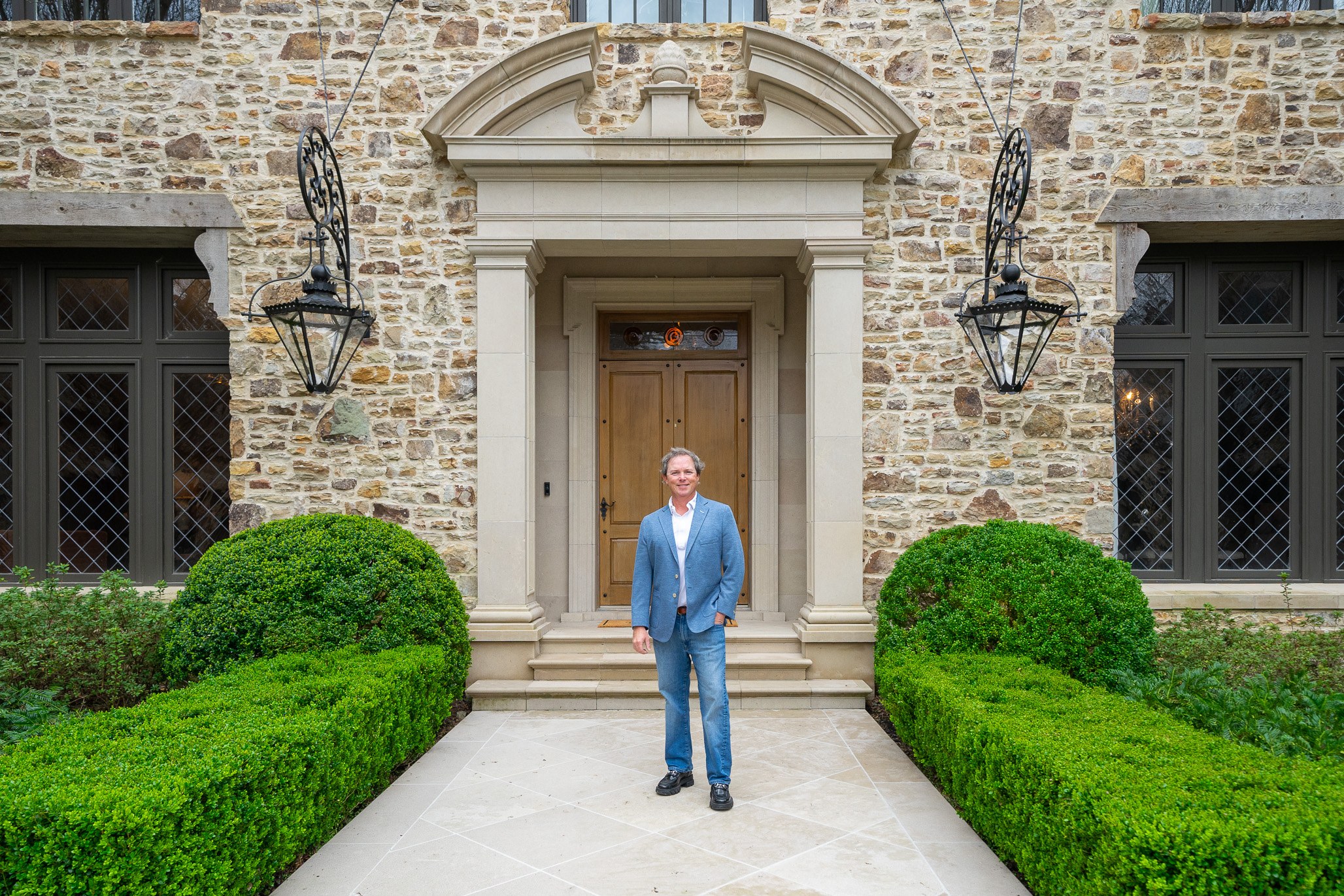 Curb Appeal Photography client in front of a stone estate