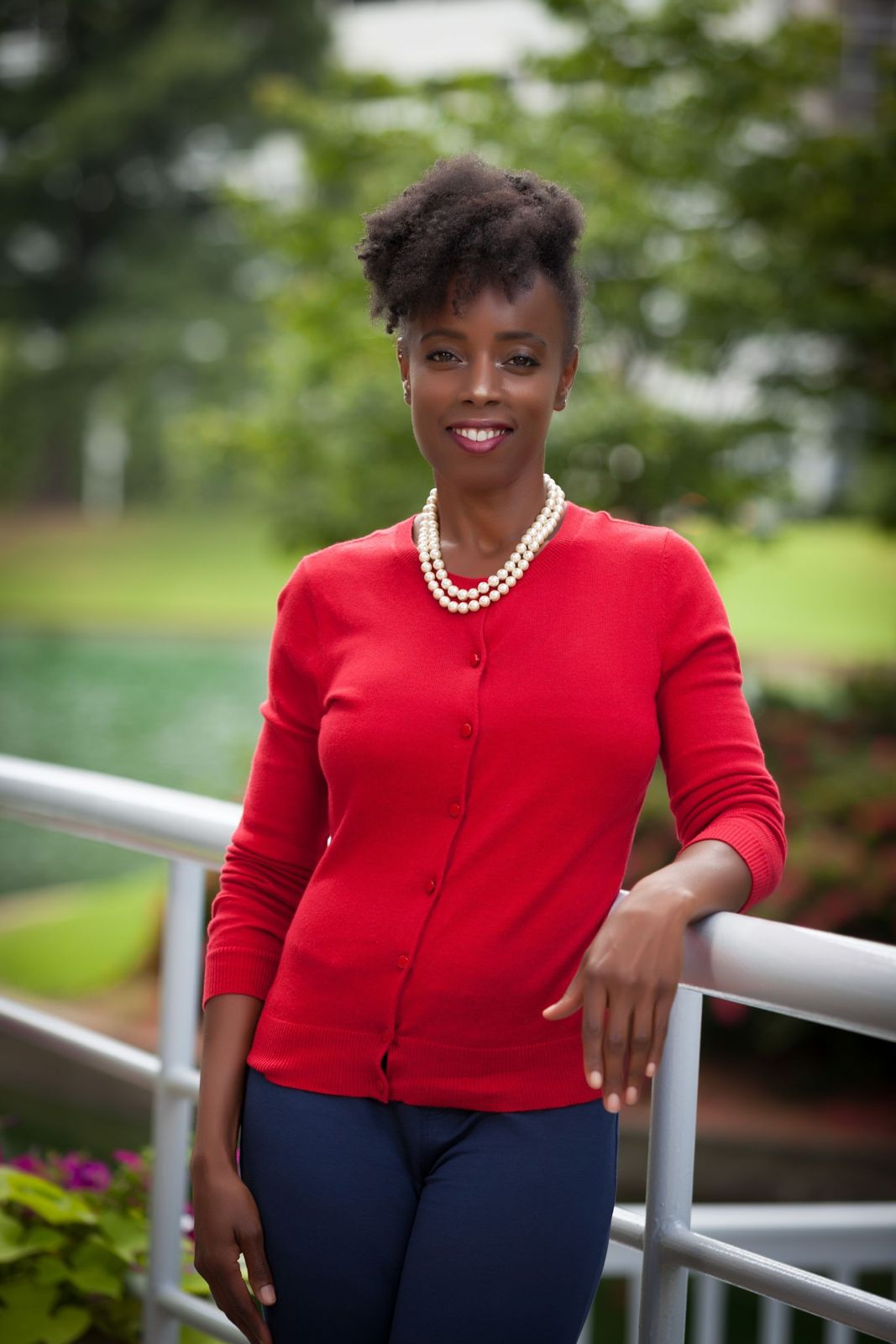 Agent in a red cardigan photographed outdoors