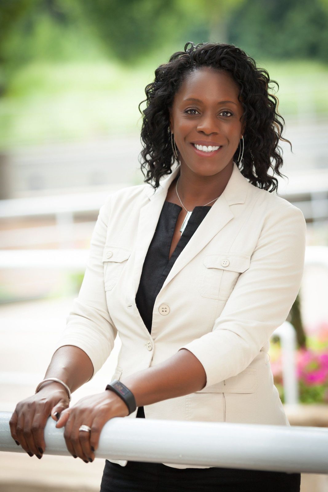 Agent in a light blazer photographed outdoors