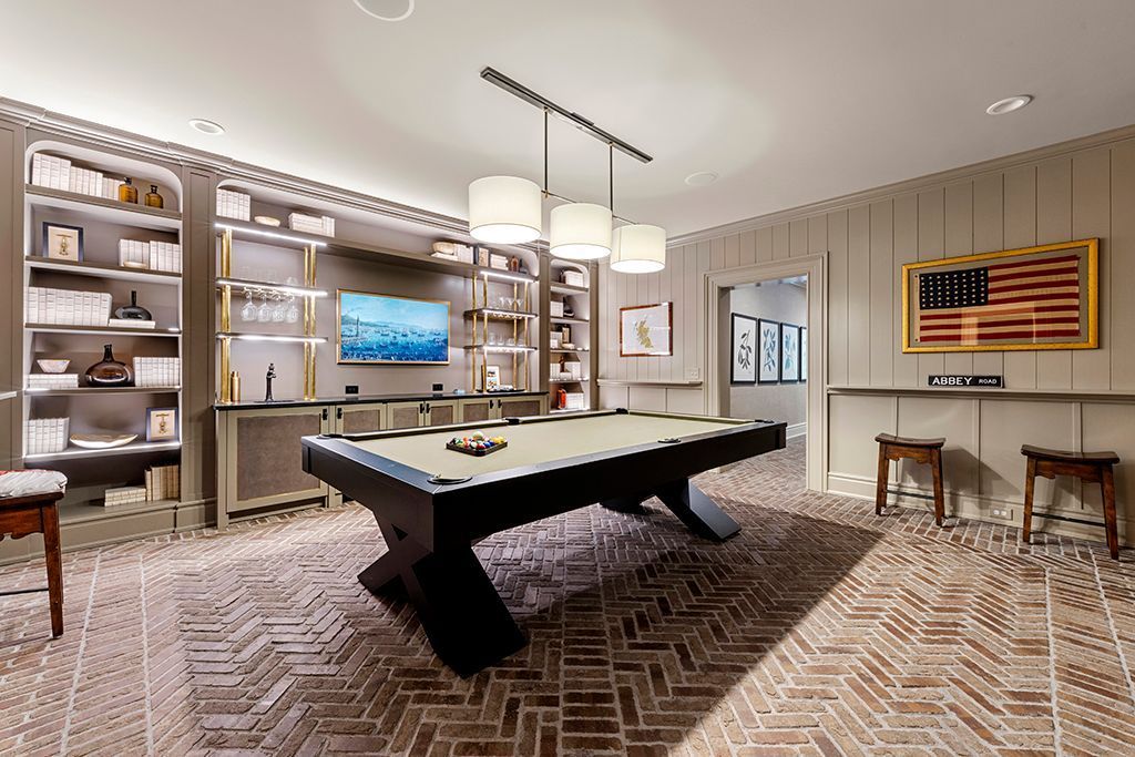 Pool room with pool table, bookshelves, and American flag art.