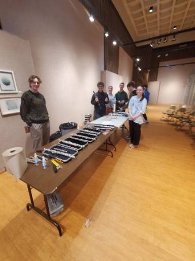 Students and volunteers prepare instruments for an Instrumental Infusion workshop