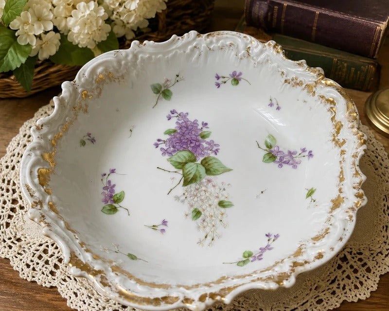 Vintage floral china and amber glass arranged on a wooden table