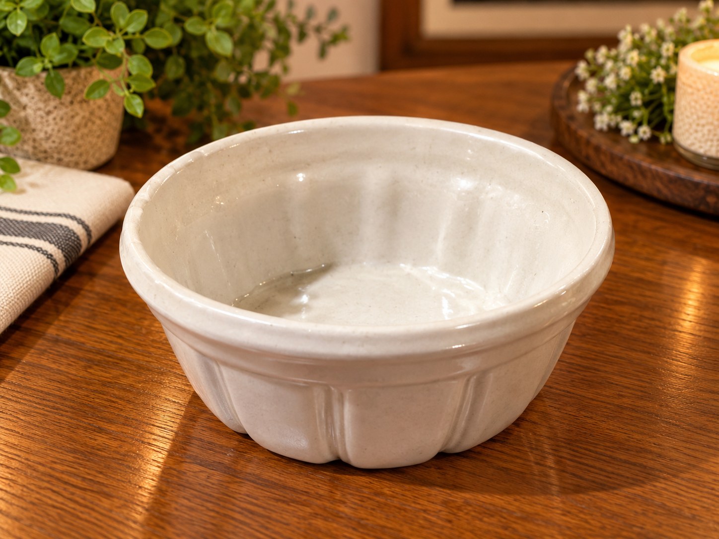 White antique stoneware bowl with a paneled form