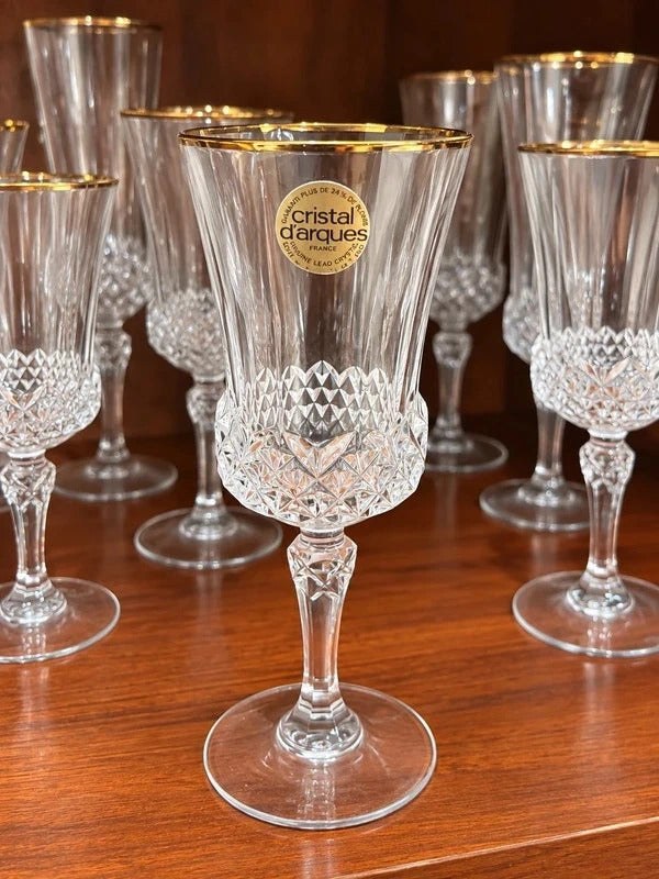 Set of clear vintage crystal wine glasses with gold rims