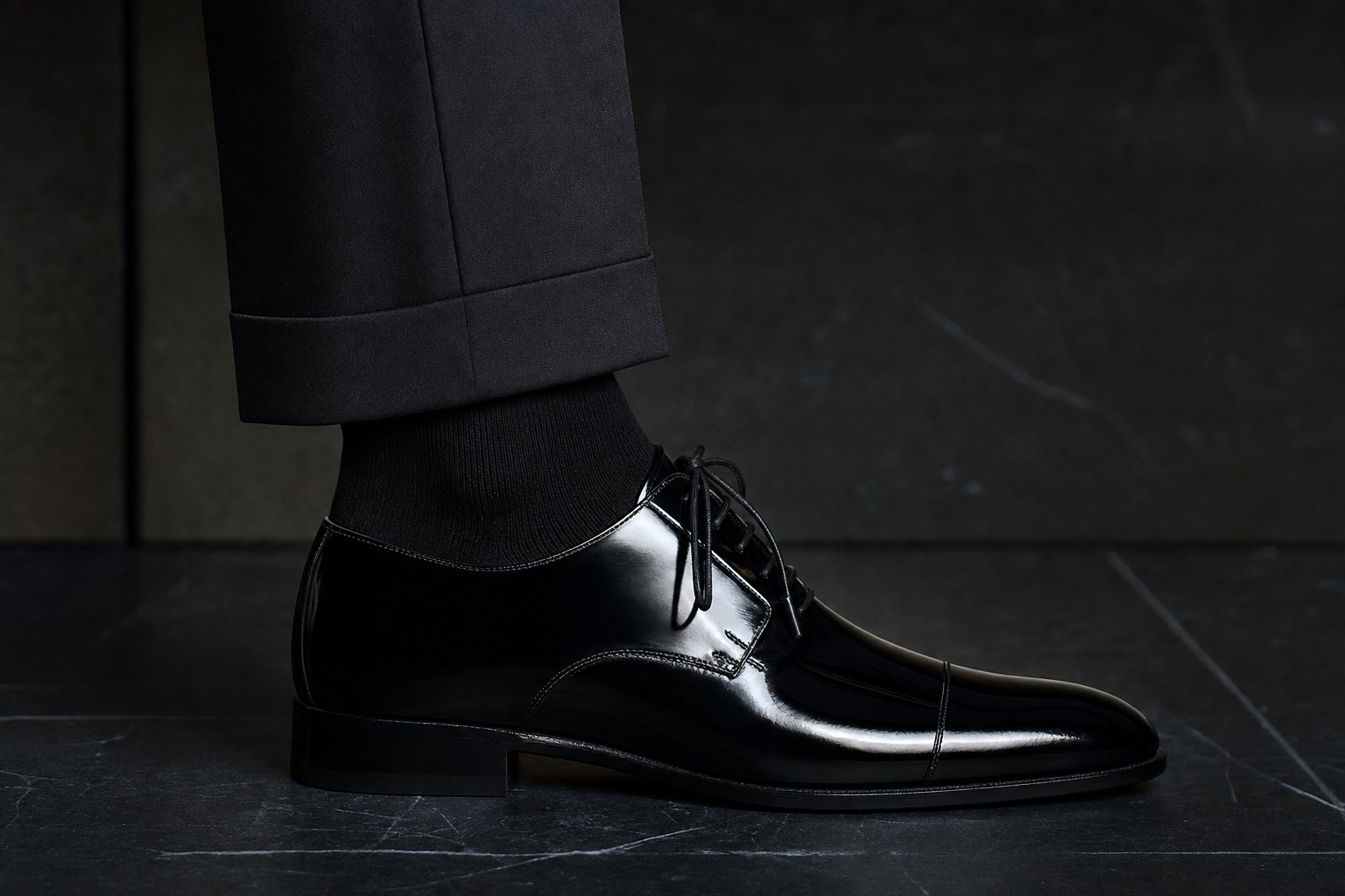 Black dress sock with black tuxedo trousers and polished black formal shoe