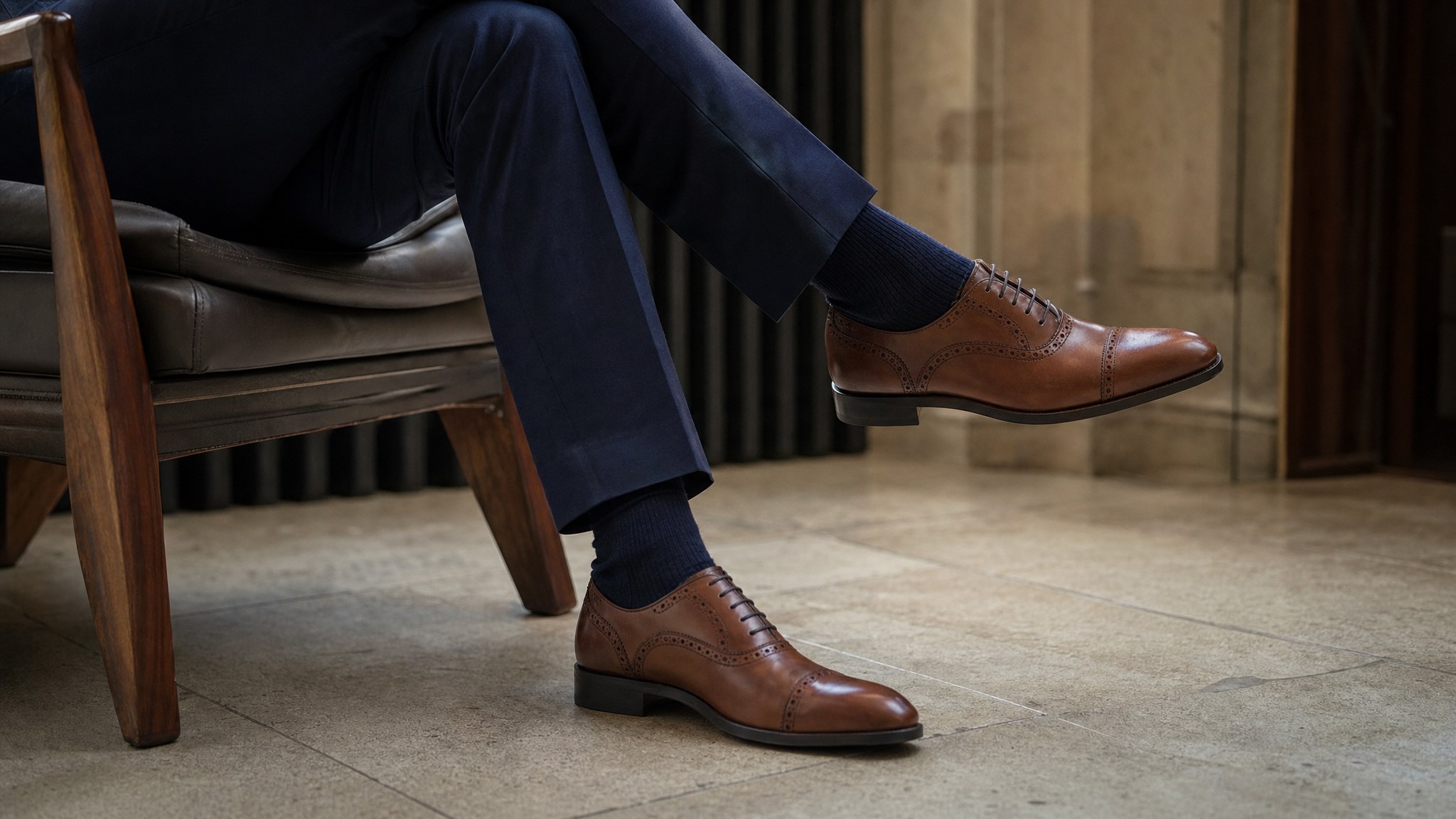 Navy suit trousers, navy dress socks, and brown brogue shoes