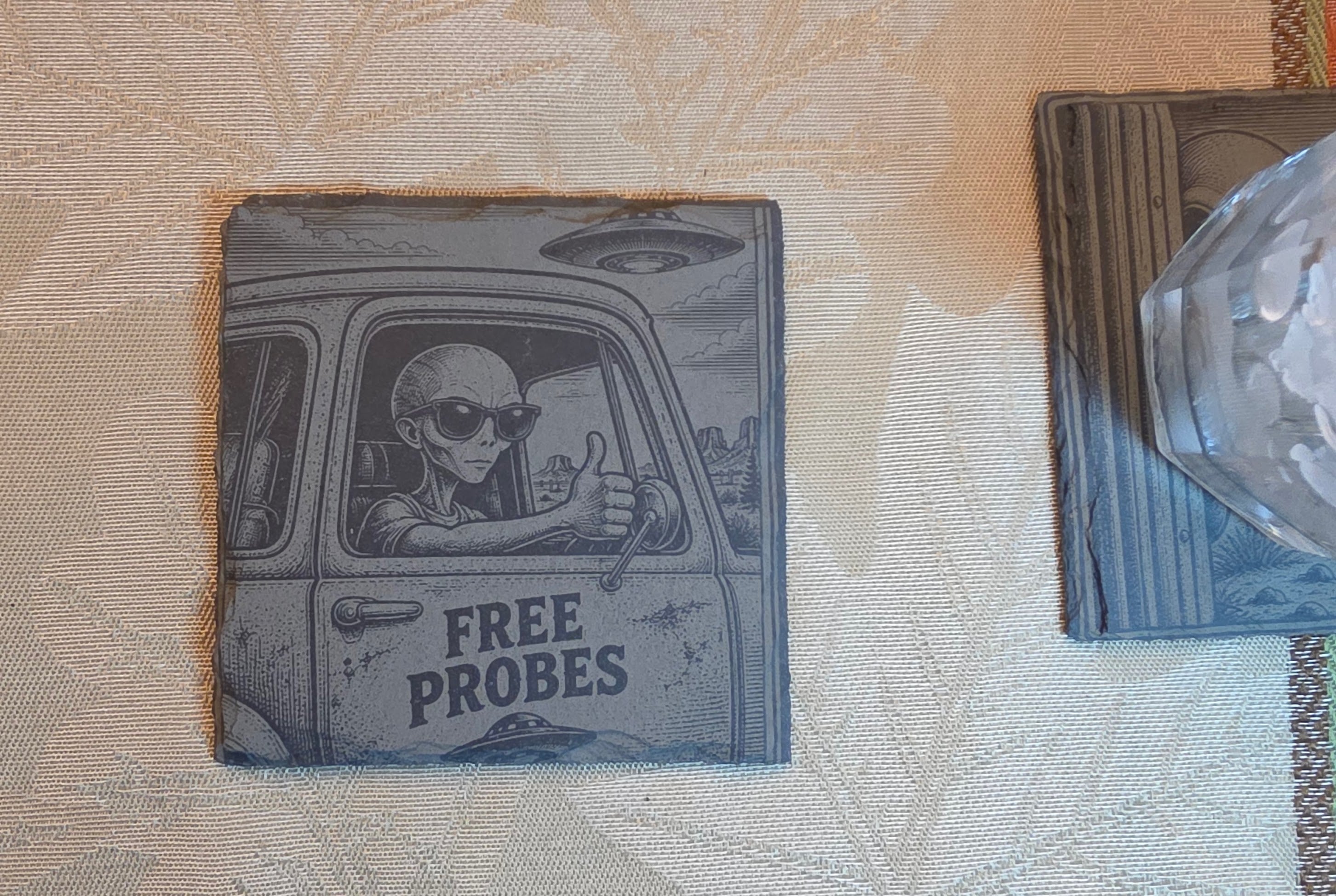 Roswell coaster on a tabletop with a wrapped gift