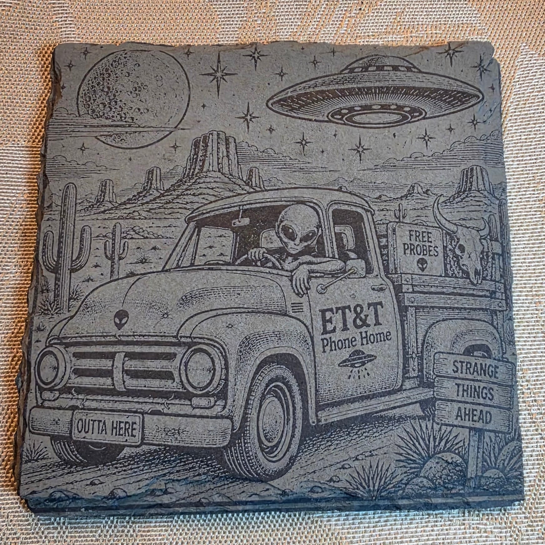 ET&T alien slate coaster on a tabletop
