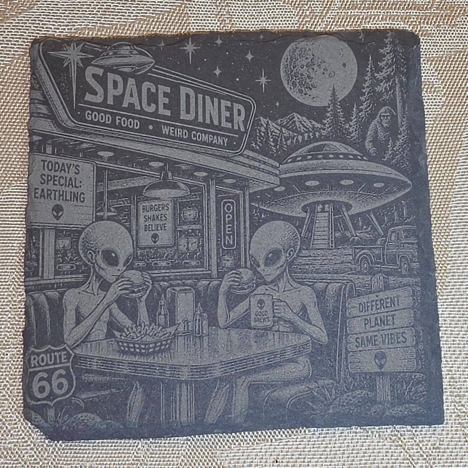 Space Diner alien slate coaster on a tabletop