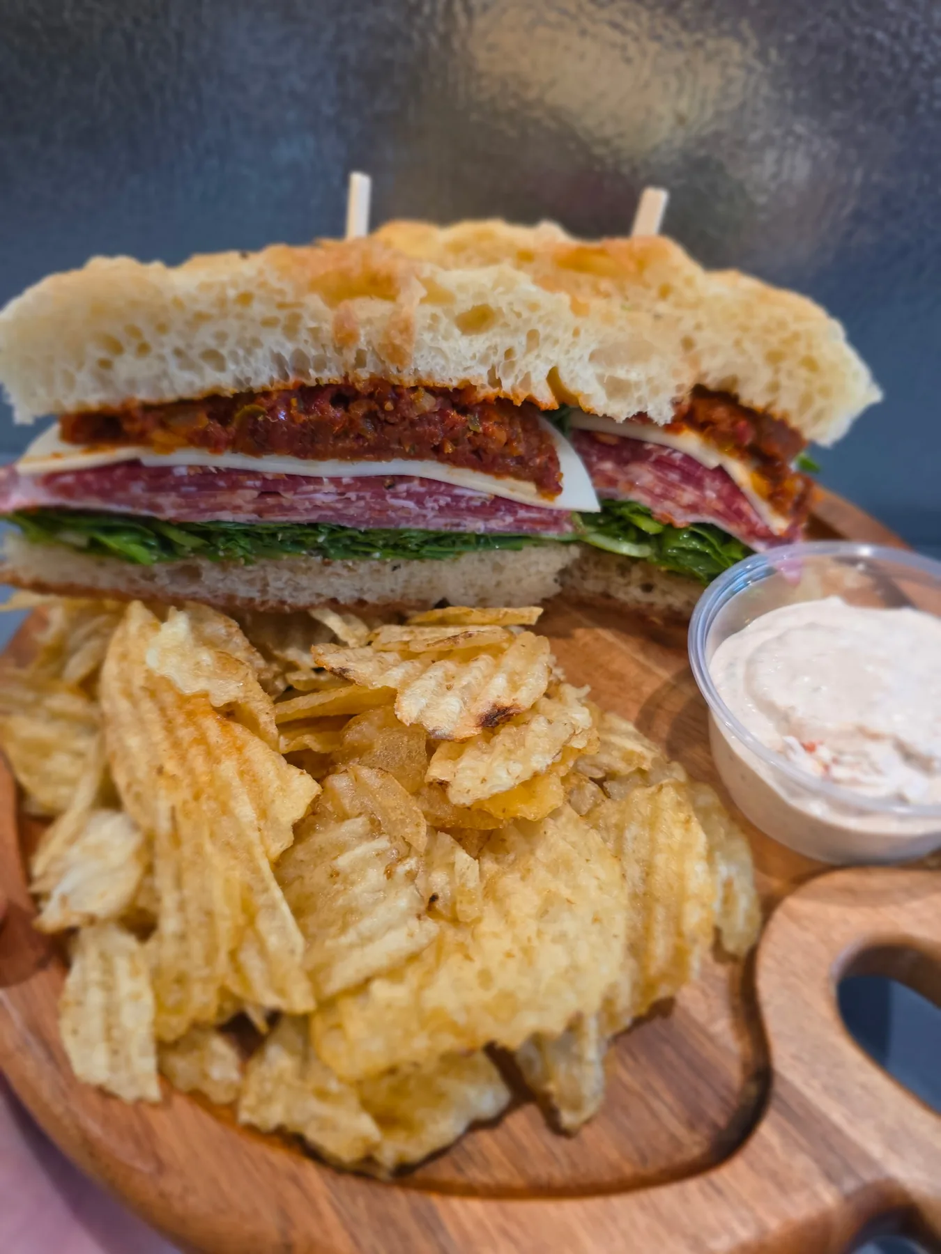 A focaccia sandwich served with chips