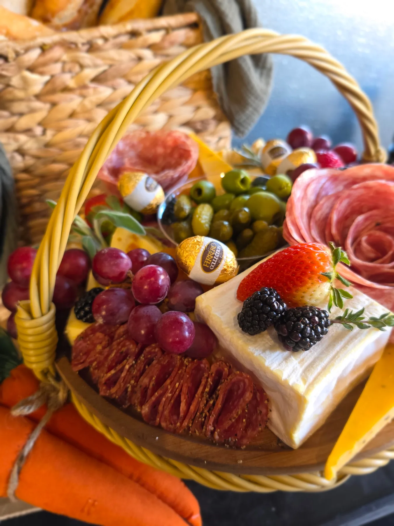 A basket of charcuterie with fruit and cheese
