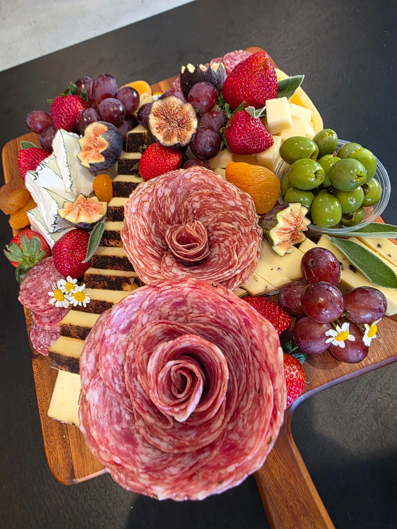 A grazing board with a central salami rose