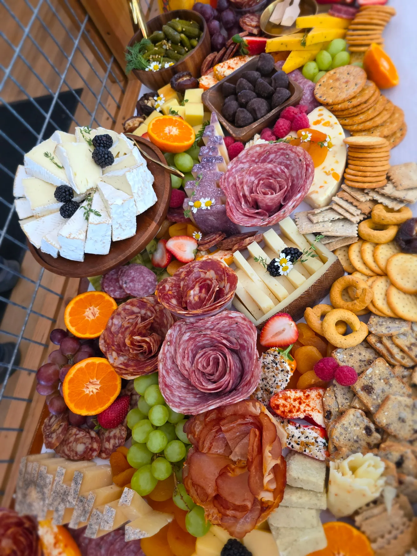 A detailed grazing board with fruit and cheeses