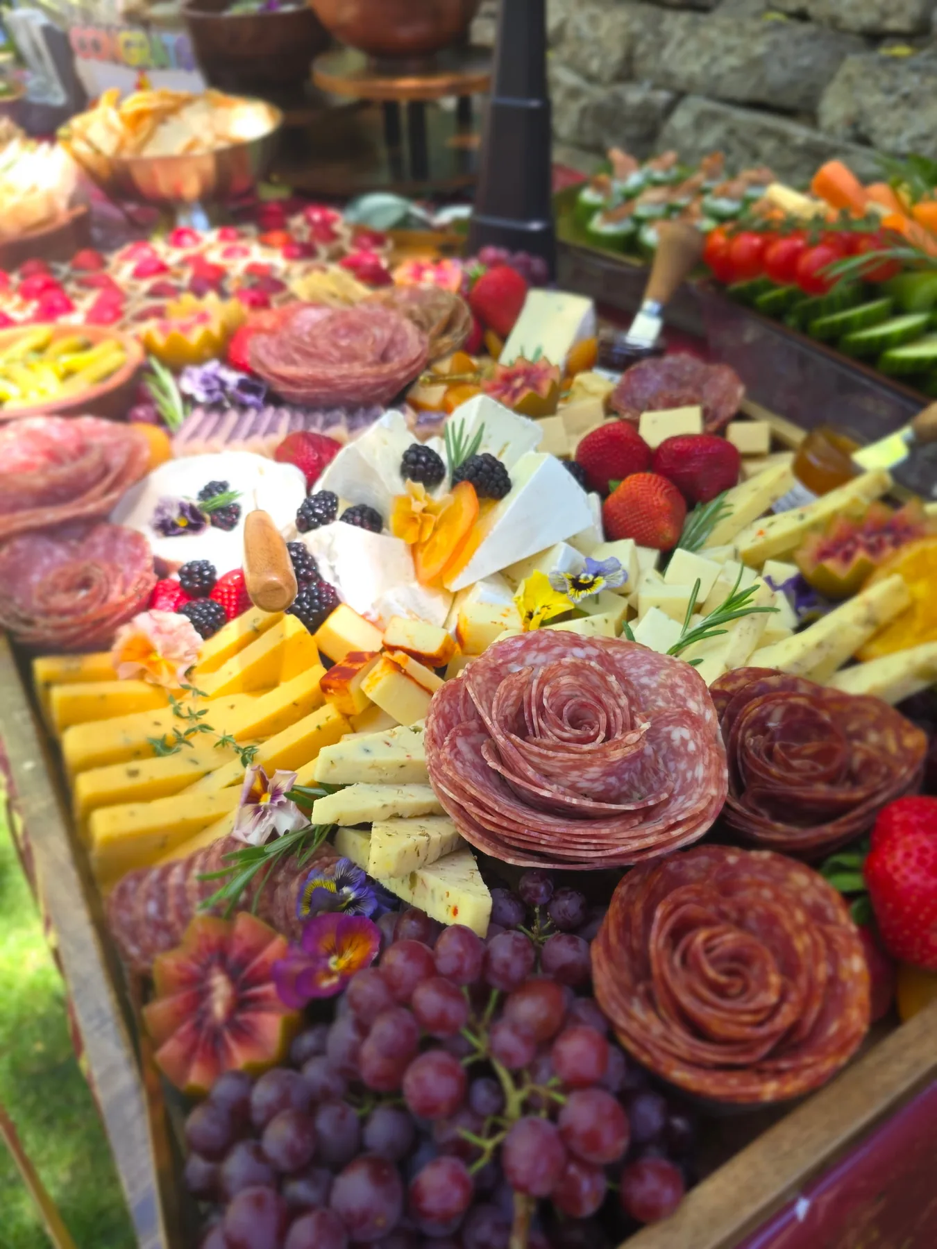A generous charcuterie table with colourful fruit