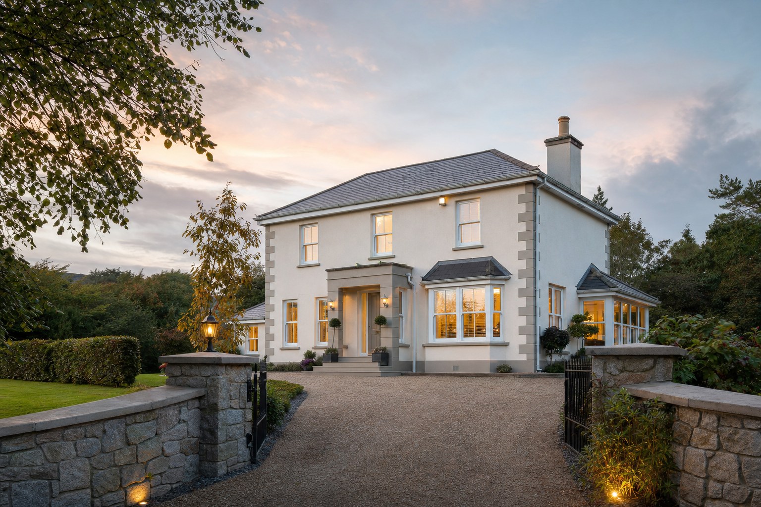 Well-presented detached Irish home photographed from its driveway at dusk
