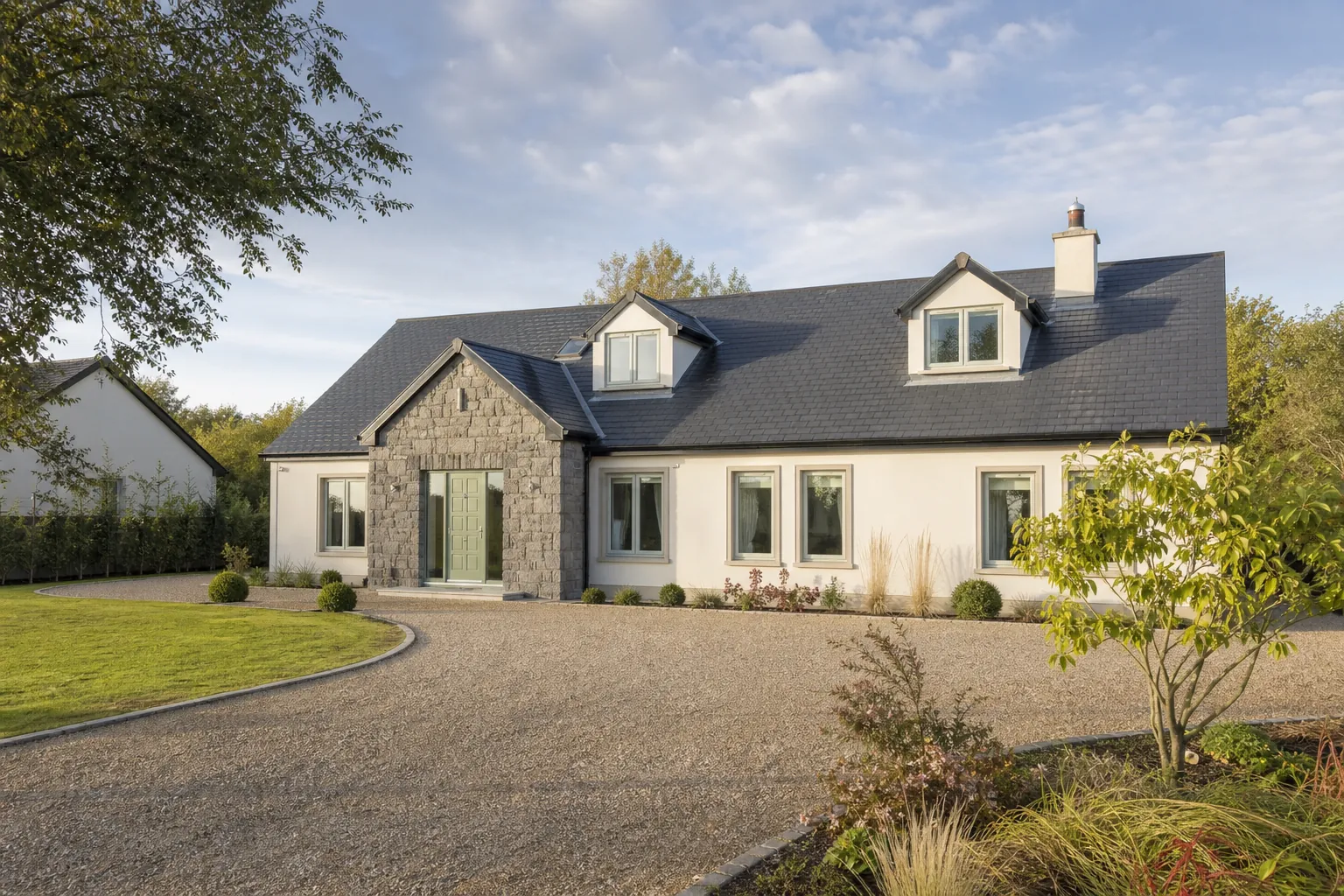 Detached home with a swept gravel approach and neat front garden