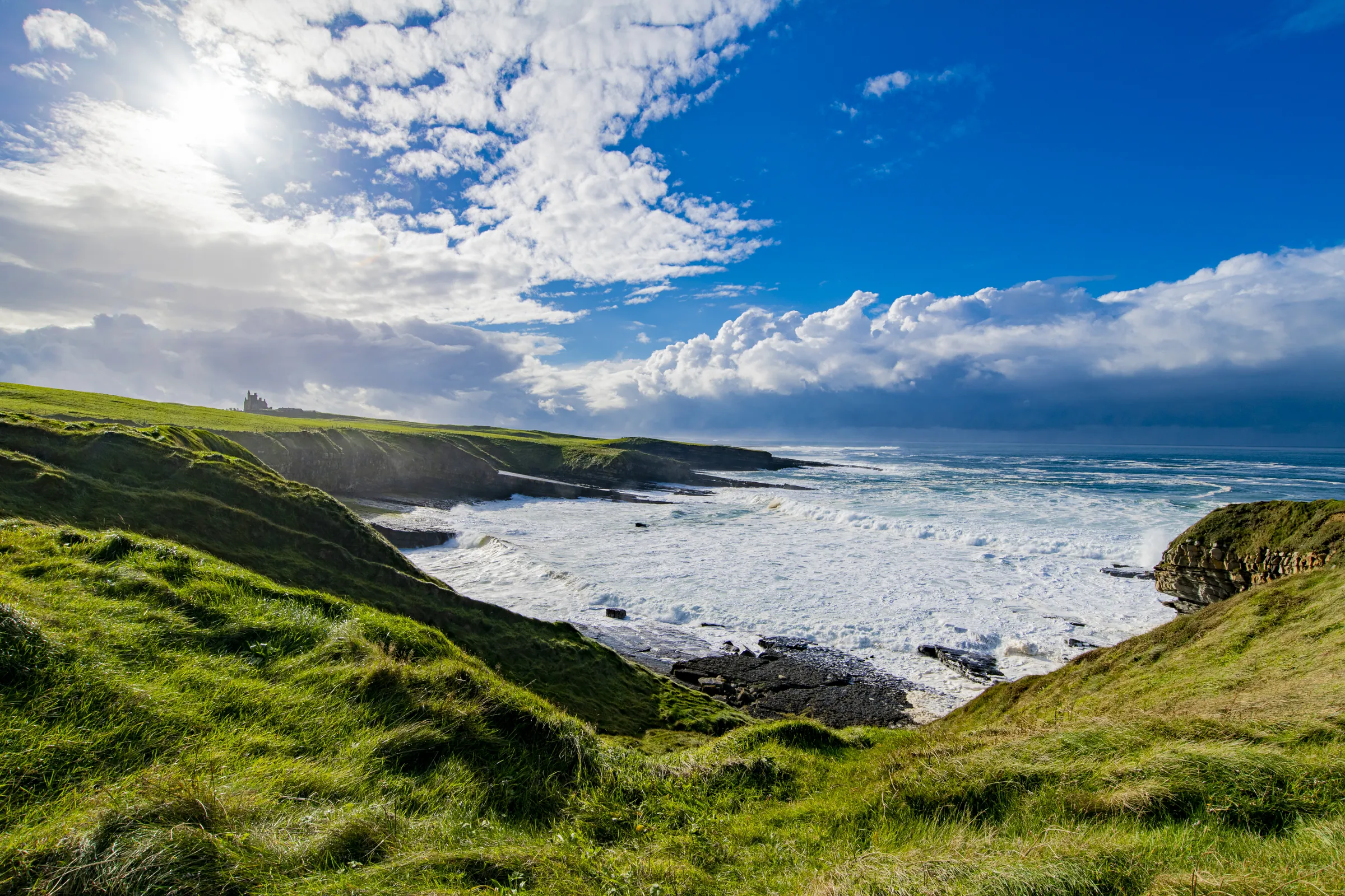 Irish coastline with green cliffs and rolling waves
