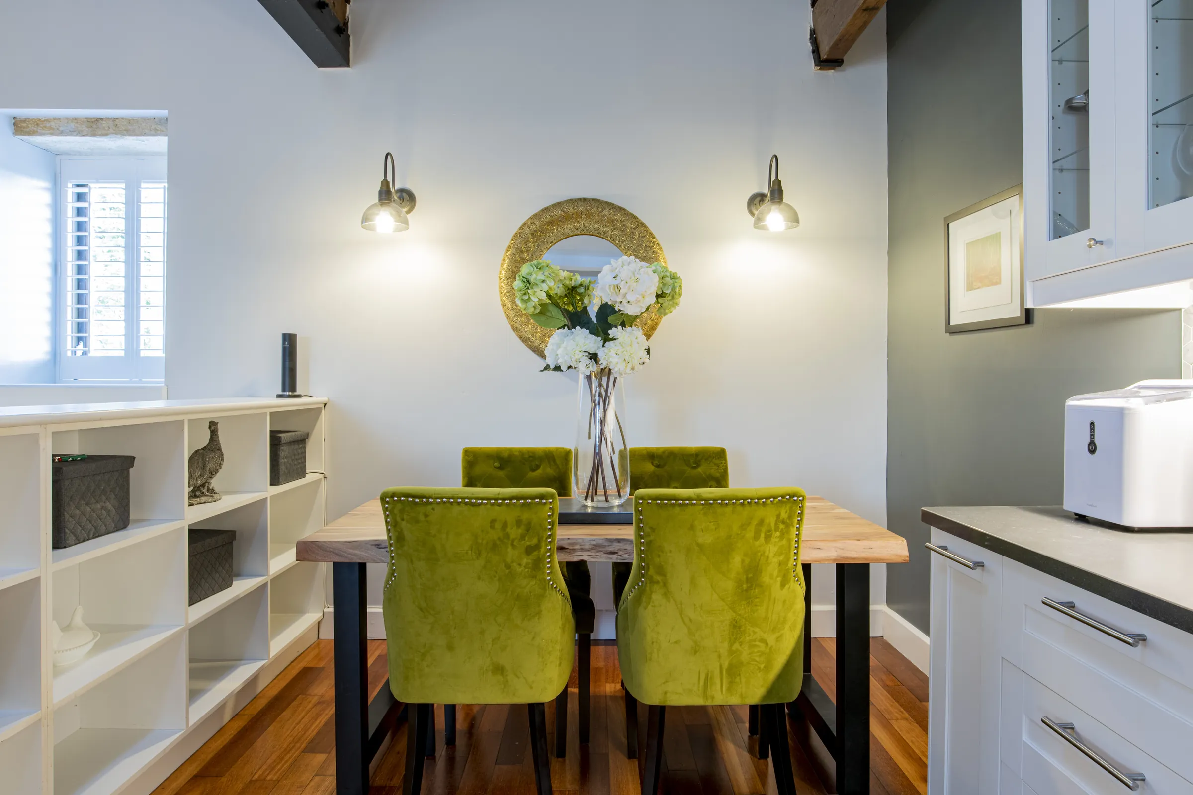 Kitchen dining space with green chairs