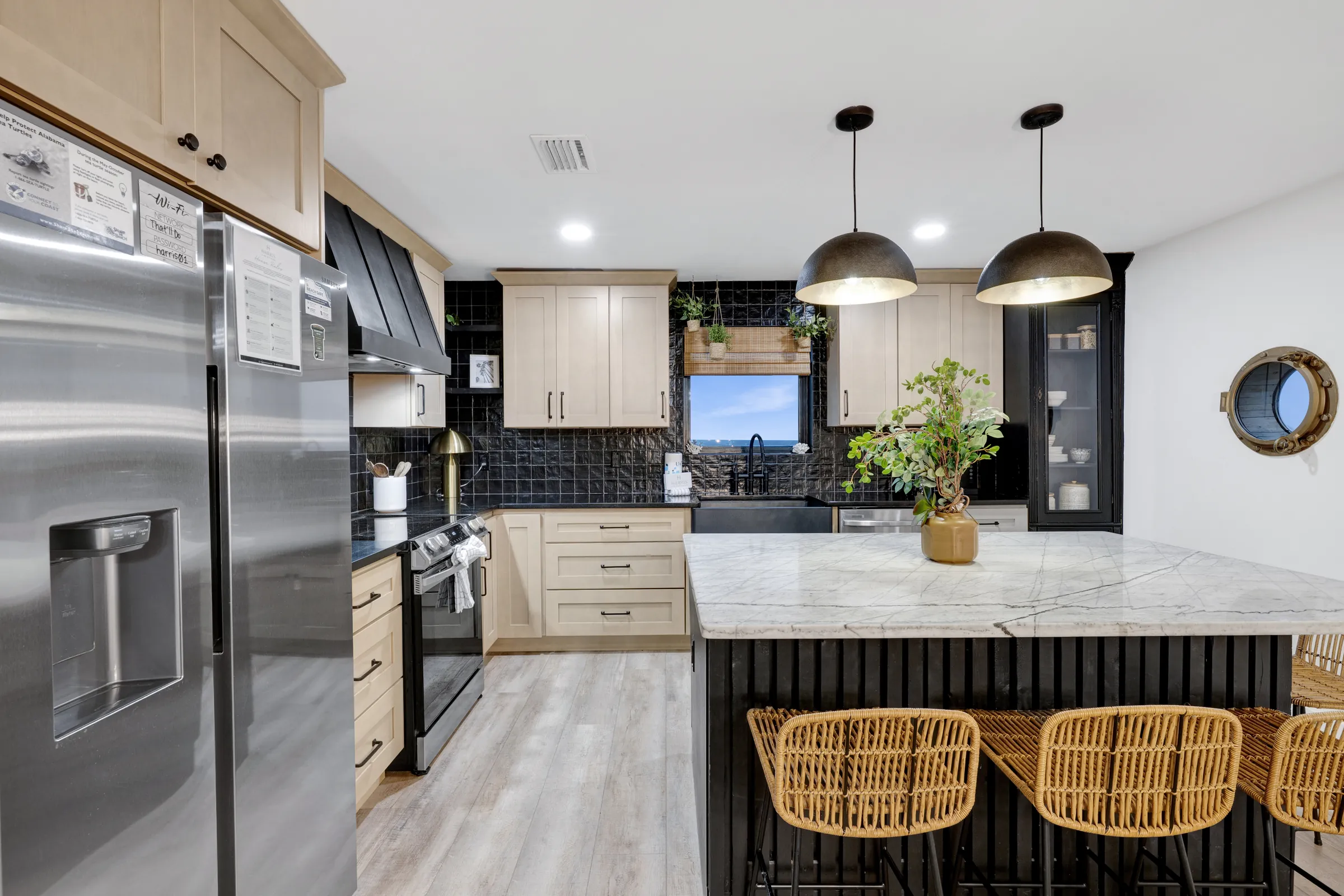 Kitchen with a marble island and woven stools