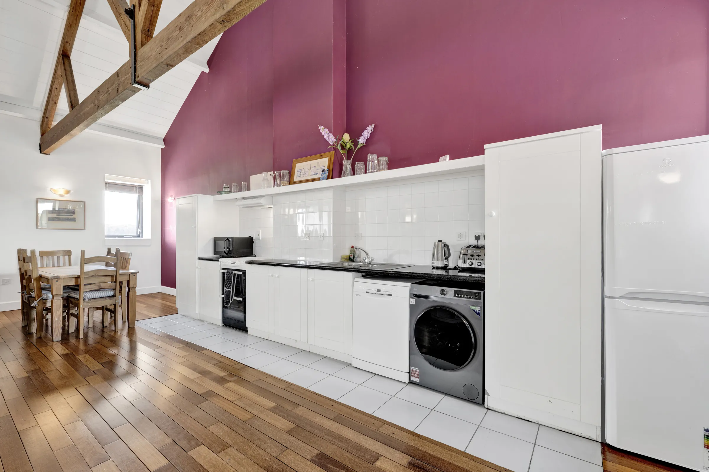 Kitchen and dining area with a vaulted ceiling