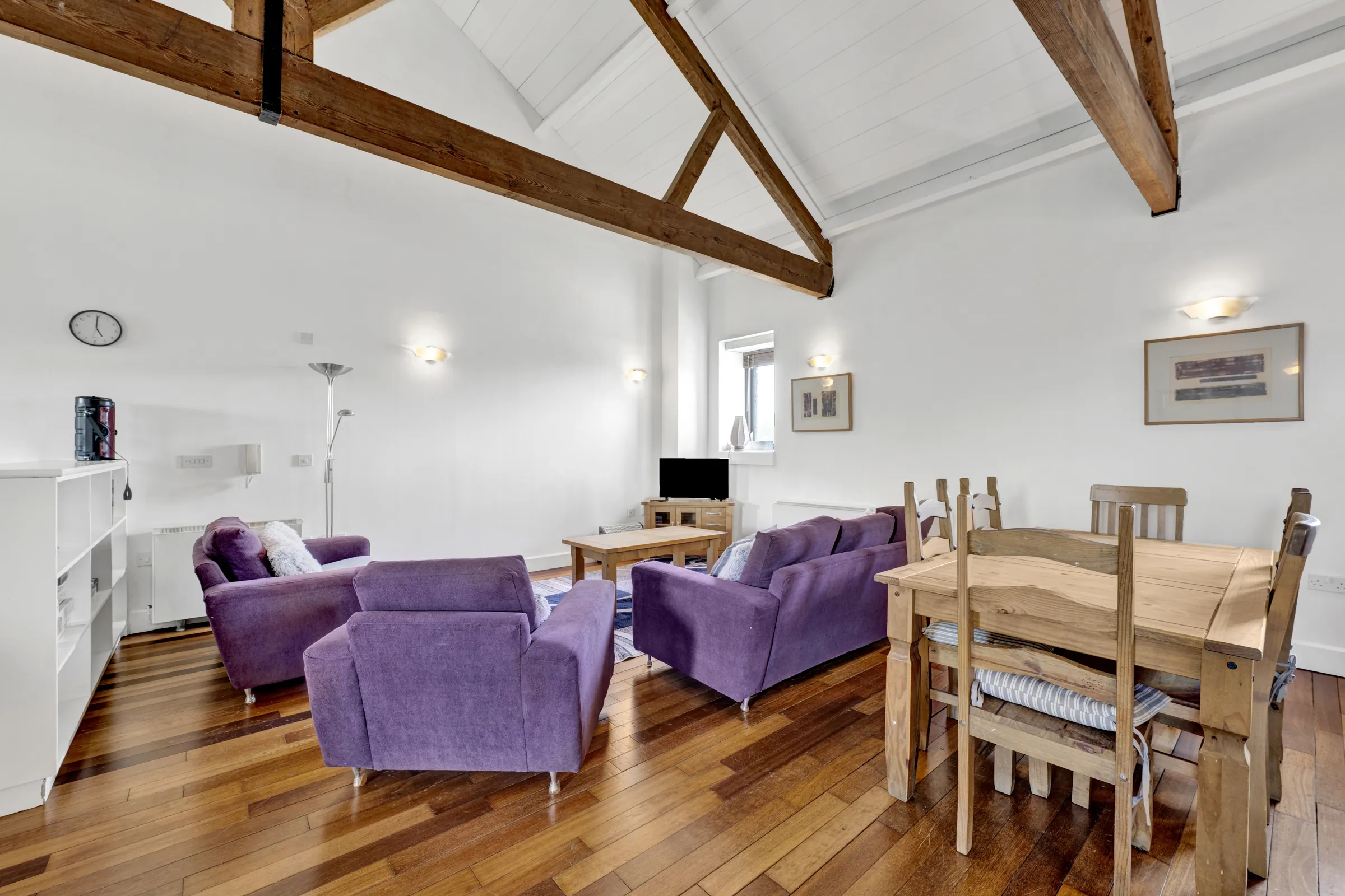 Open-plan living and dining room with timber beams