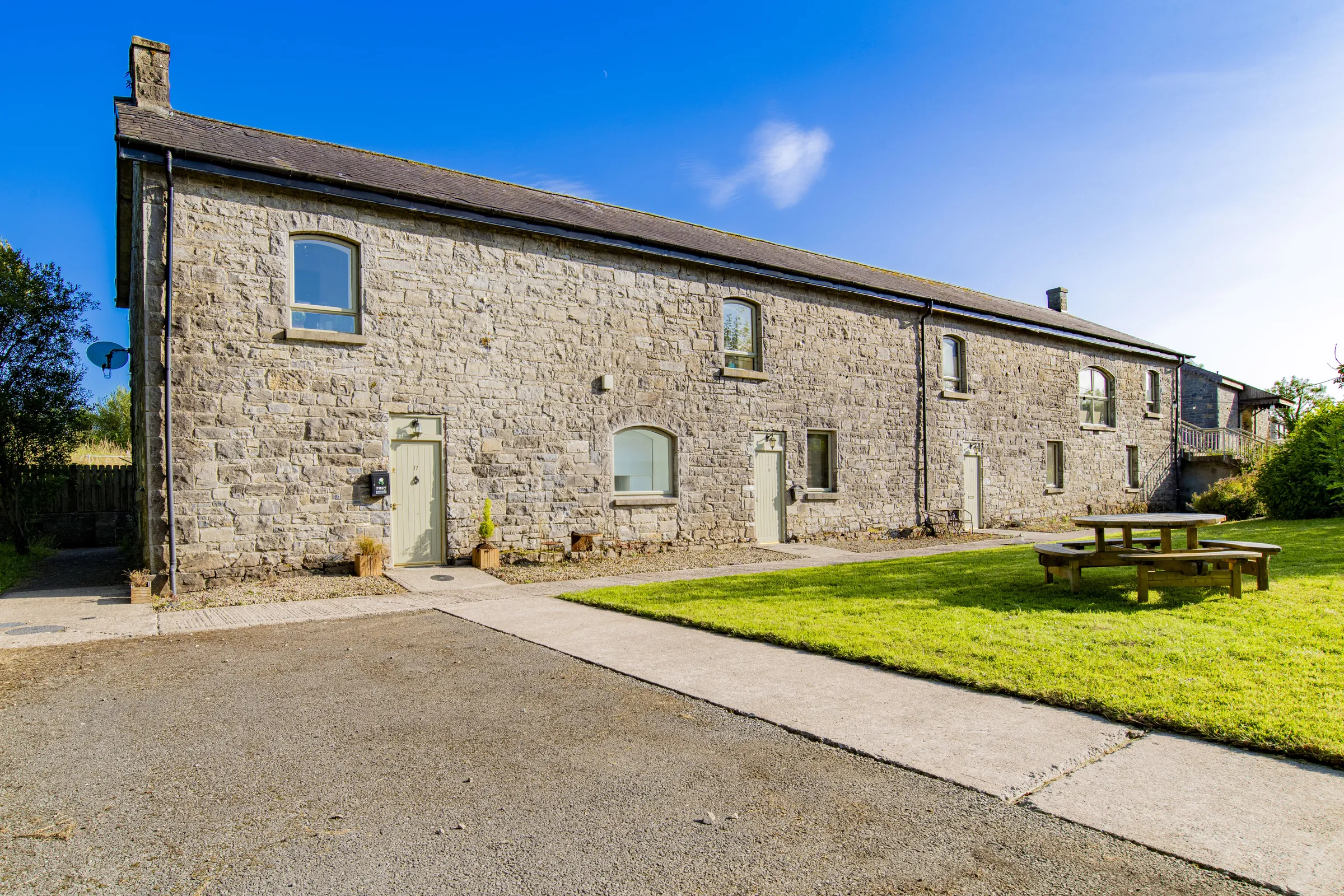 Stone cottage exterior with a picnic table