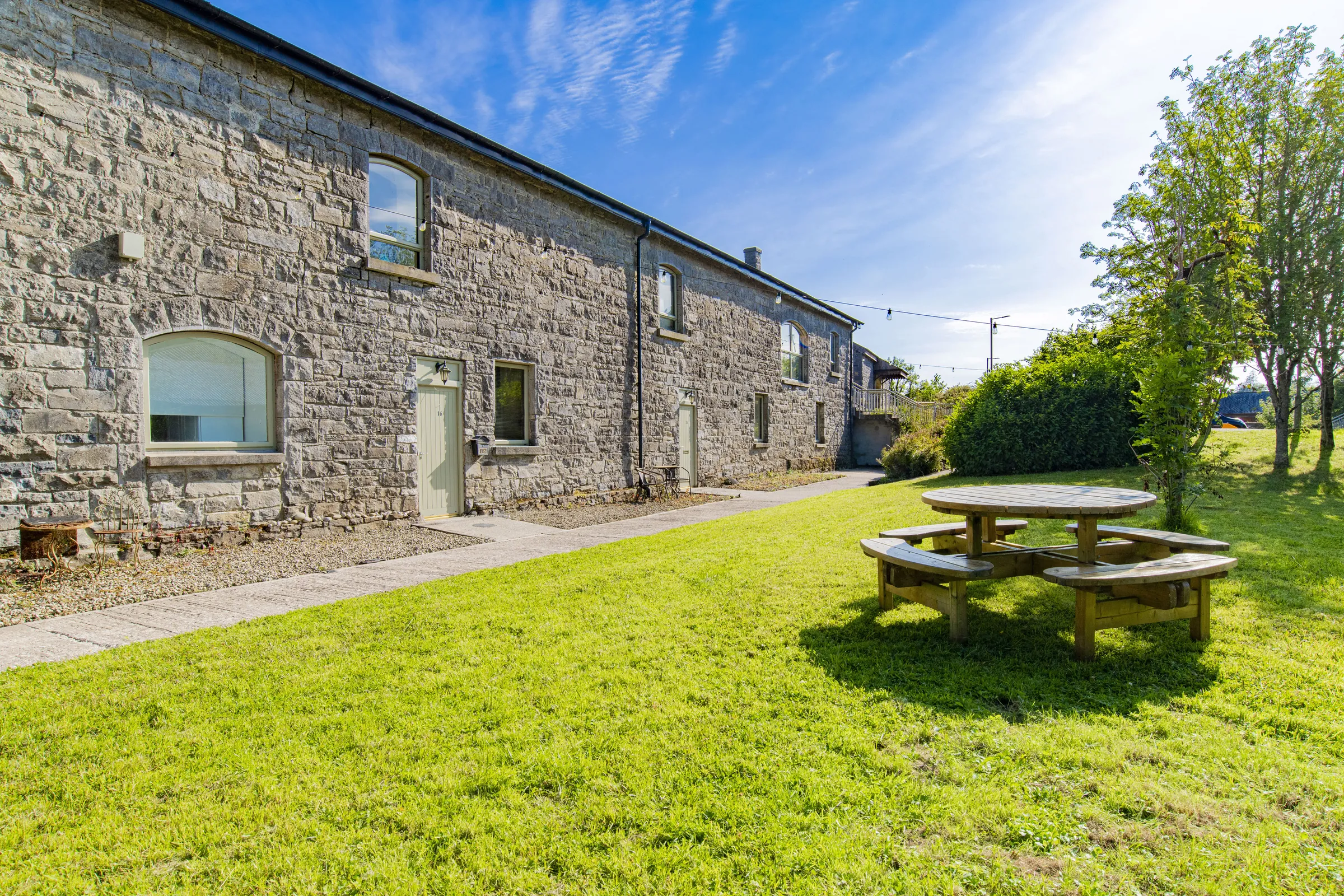 Stone cottage and garden lawn