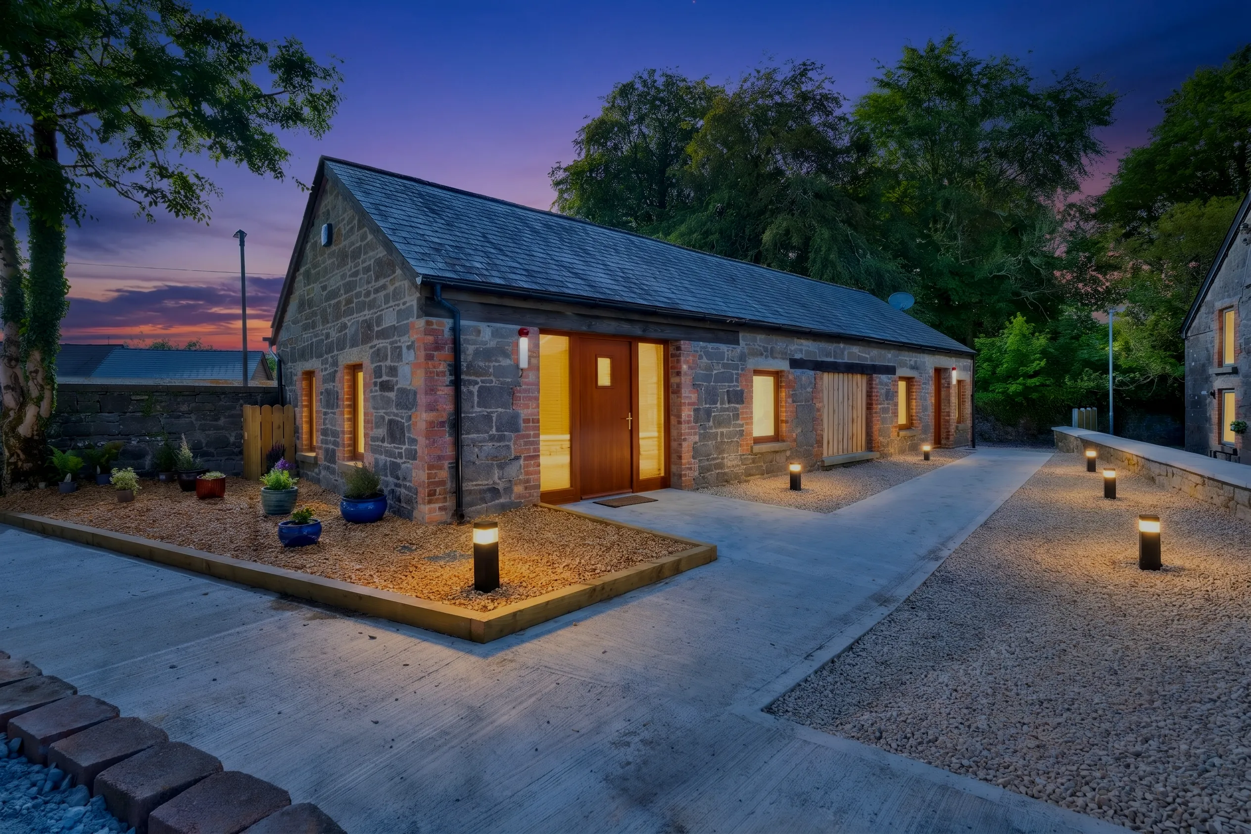 Stone outbuilding photographed at dusk