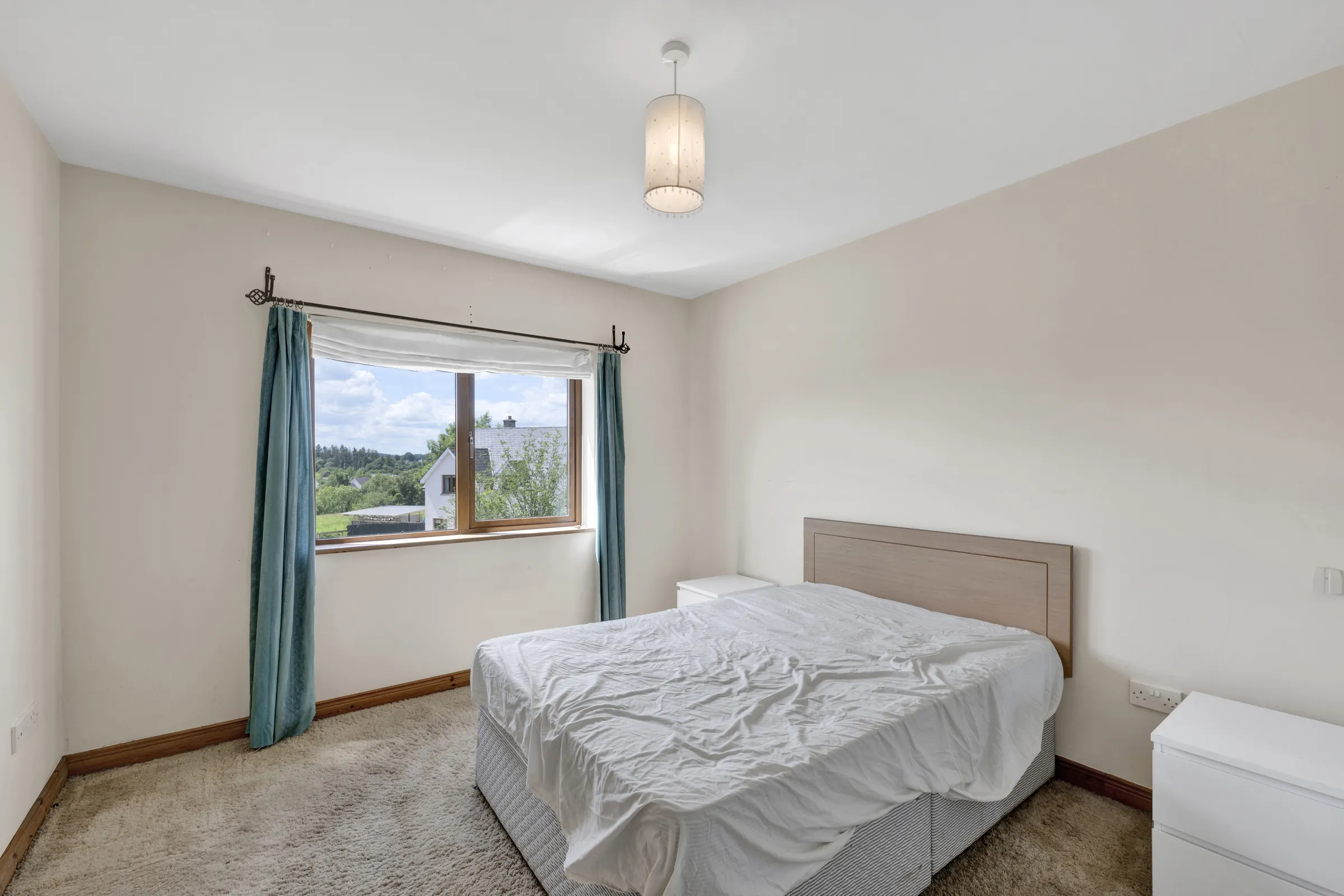 Before virtual staging: bedroom with an unmade bed and plain furnishings