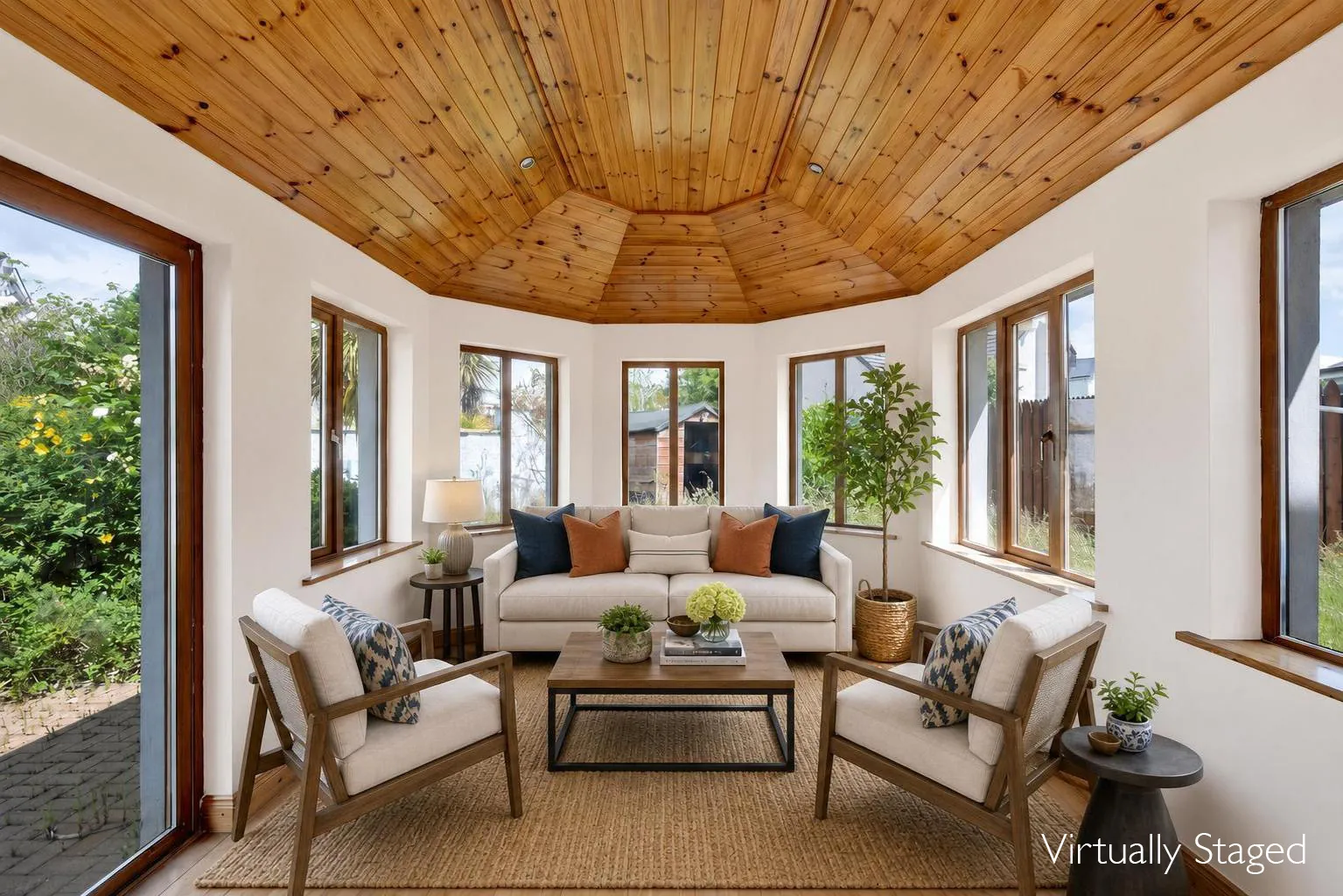 After virtual staging: a sunroom arranged as a bright sitting room