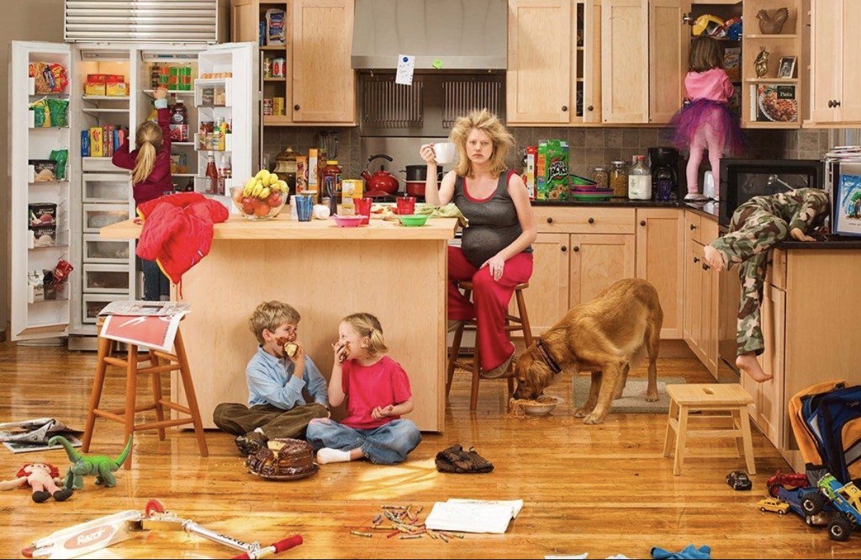 A busy kitchen moment with a parent and children during a family meltdown