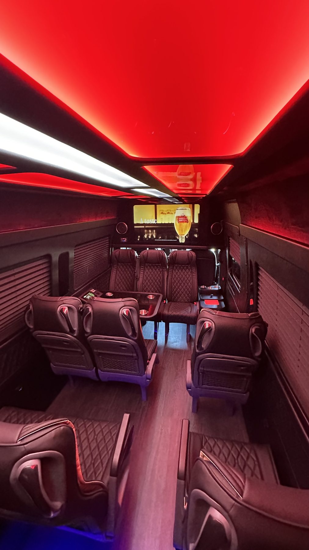 Red-lit passenger cabin with leather seating