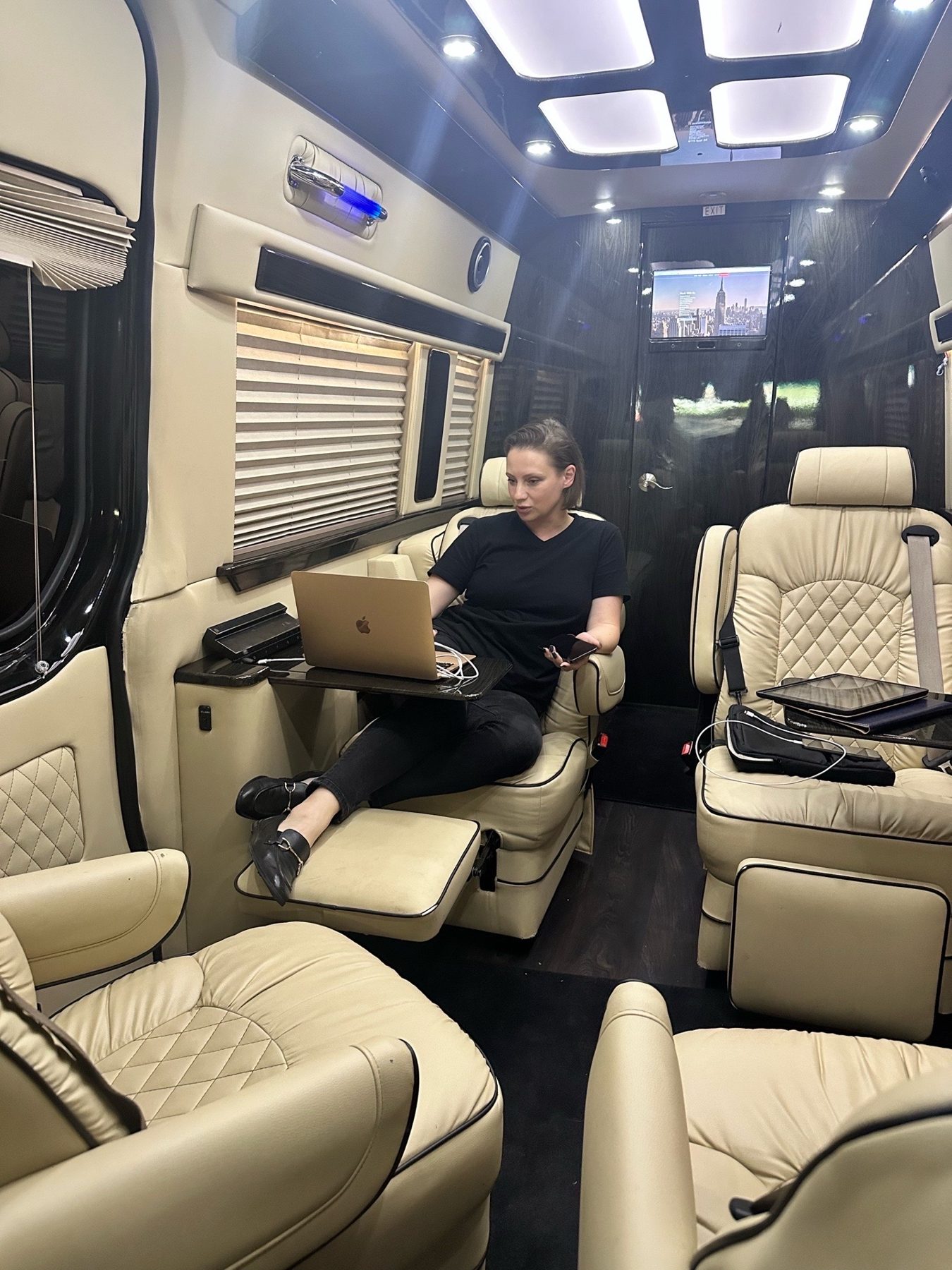 Passenger relaxing in a cream leather Sprinter cabin