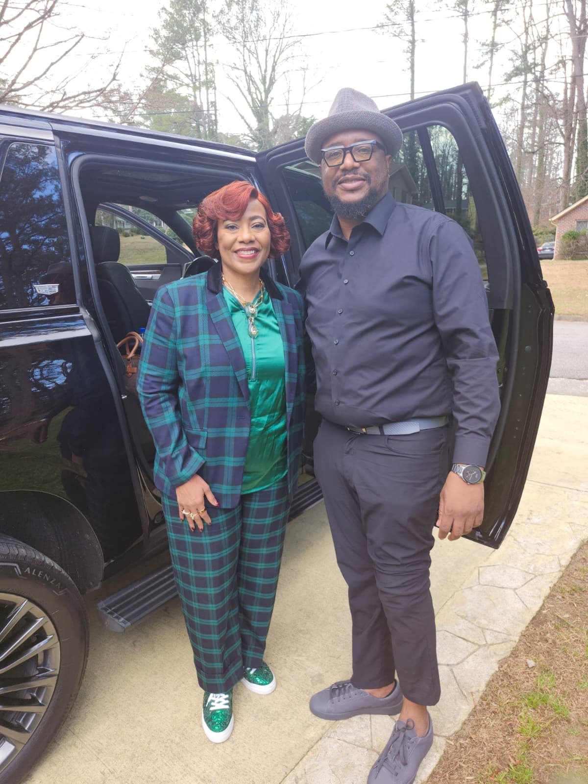 Chauffeur and guest beside an SUV